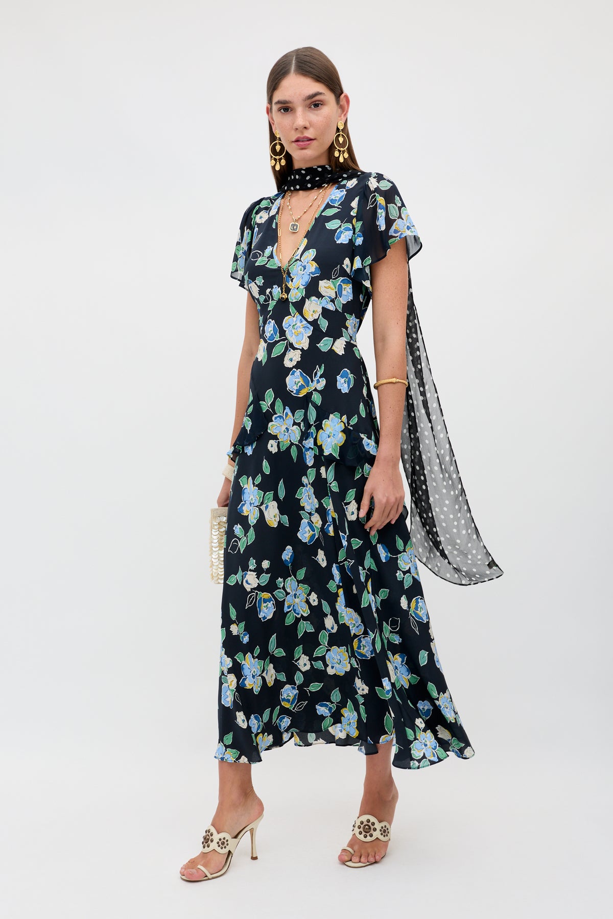 A woman wearing the Evie - Kimmie Floral Navy dress.