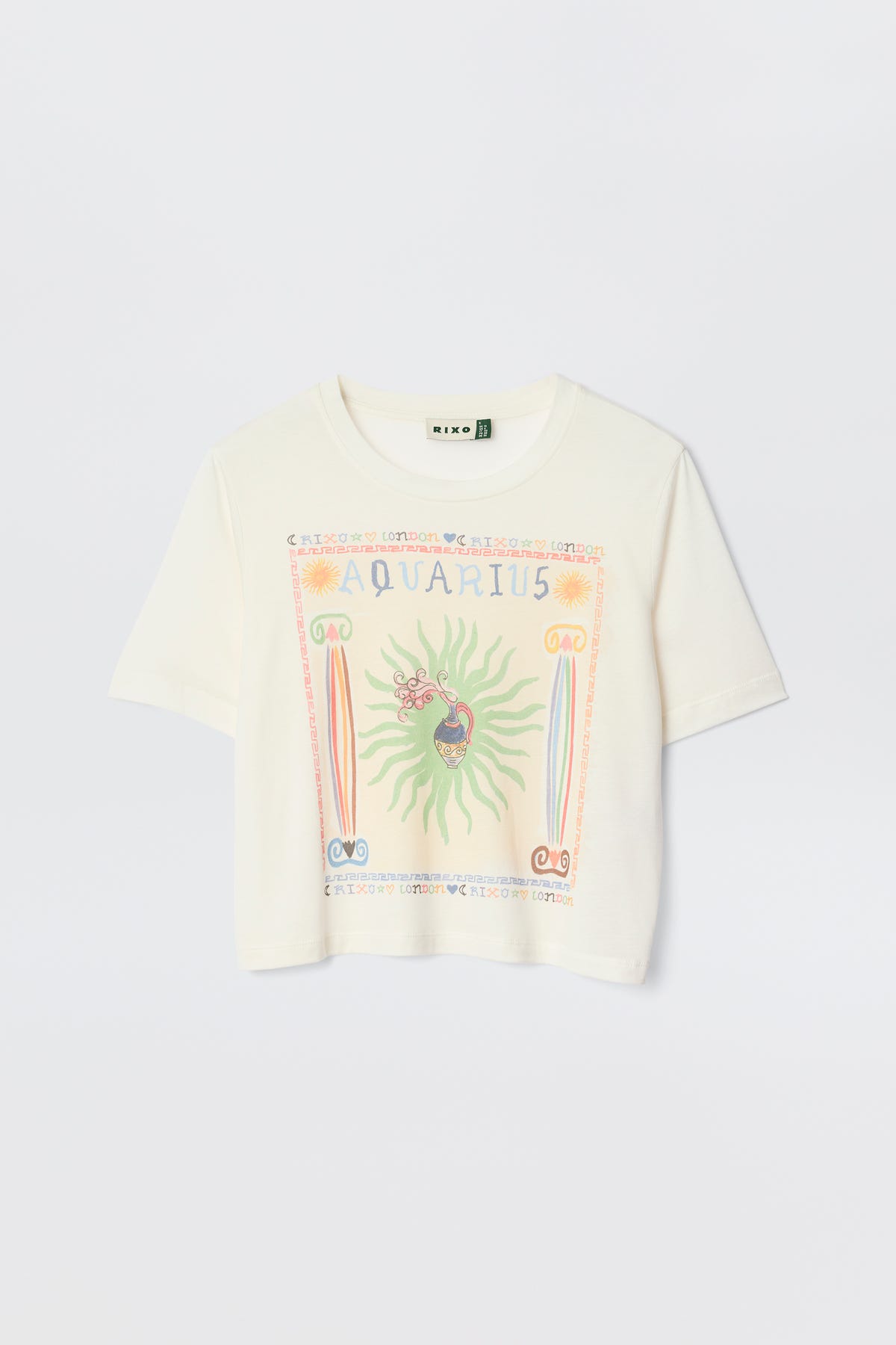 The Ria - Aquarius is a white short-sleeve tee with a vibrant Aquarius illustration, symbols, and a sunburst design—styled on a plain light background and perfect to pair with RIXO skirts for a chic look.