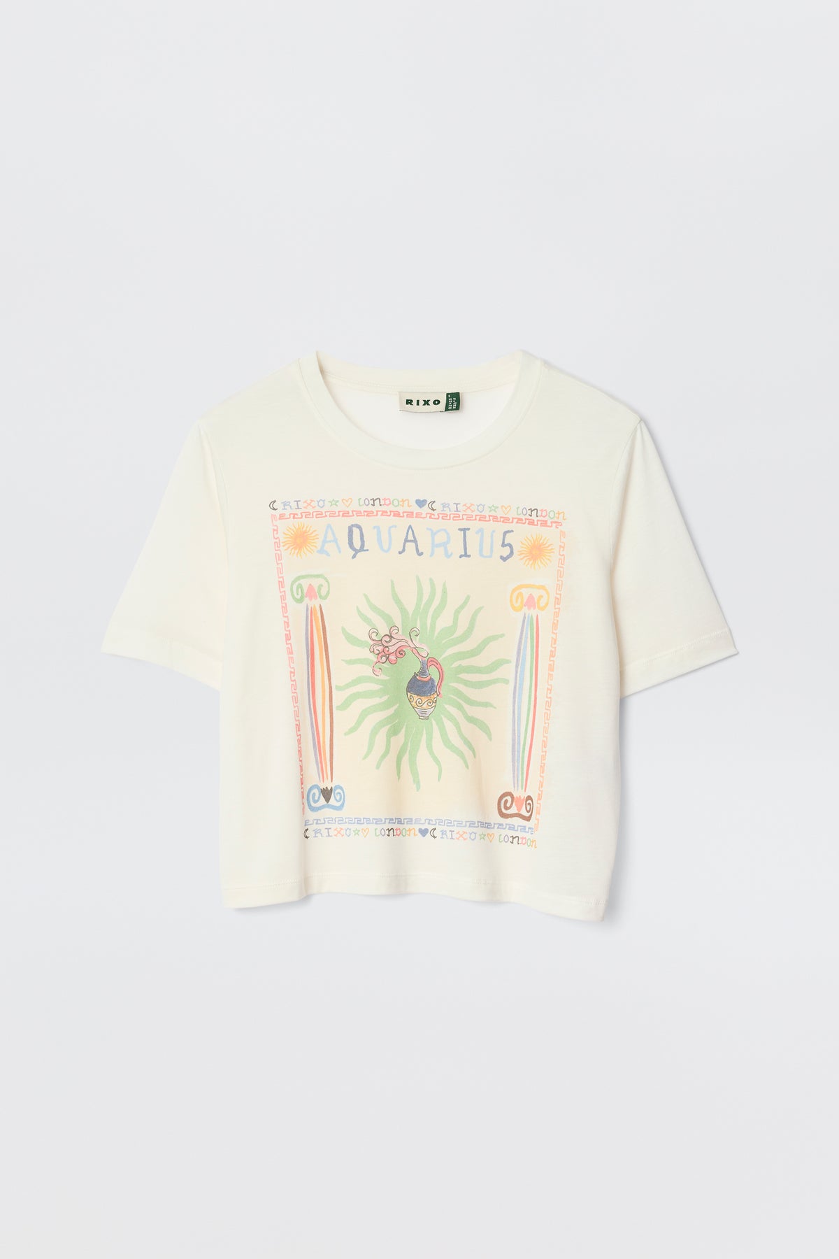 The Ria - Aquarius is a white short-sleeve tee with a vibrant Aquarius illustration, symbols, and a sunburst design—styled on a plain light background and perfect to pair with RIXO skirts for a chic look.