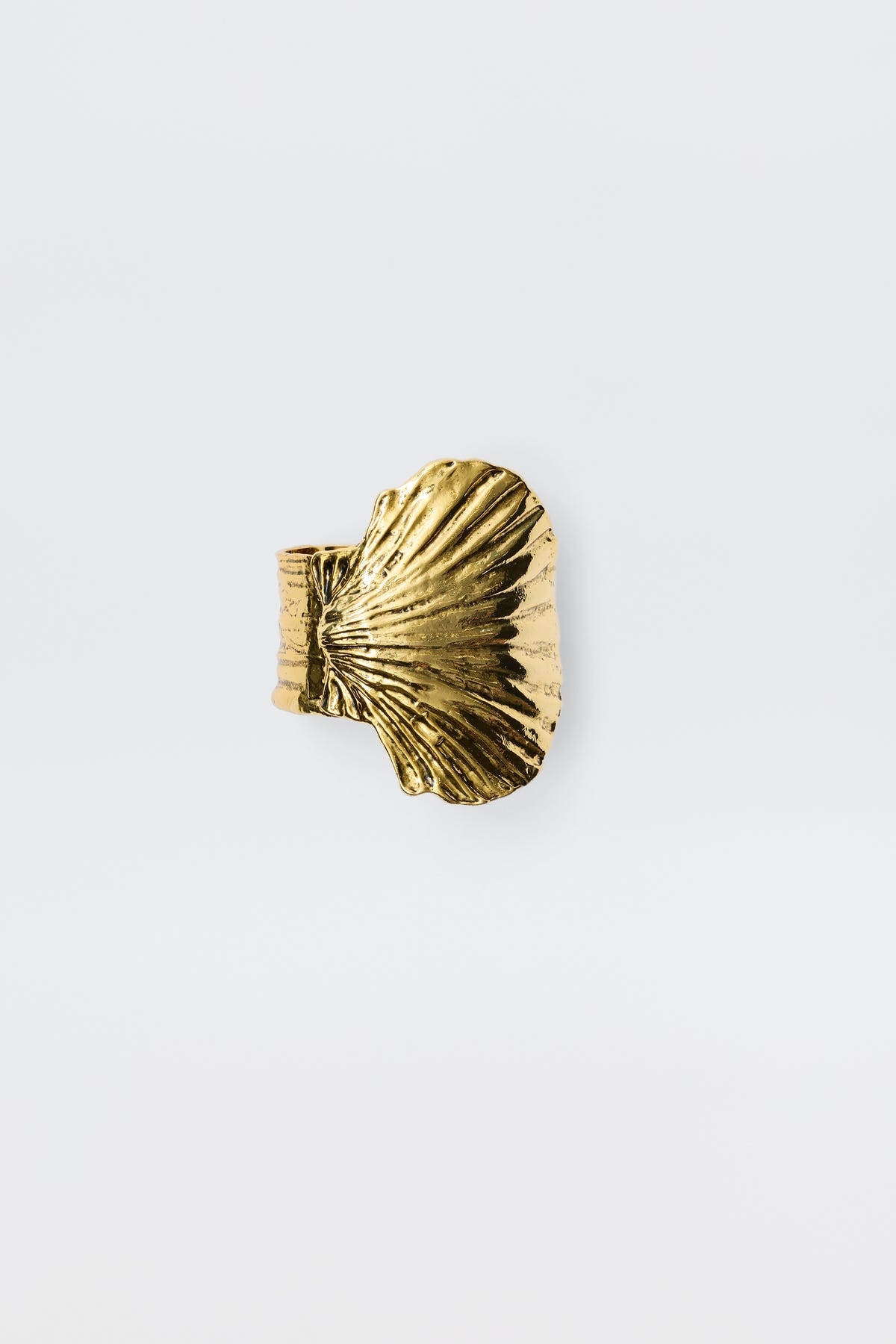 Salene - Gold is a gold ring featuring a textured, fan-shaped shell design, beautifully embodying the essence of shell jewellery on a plain white background.