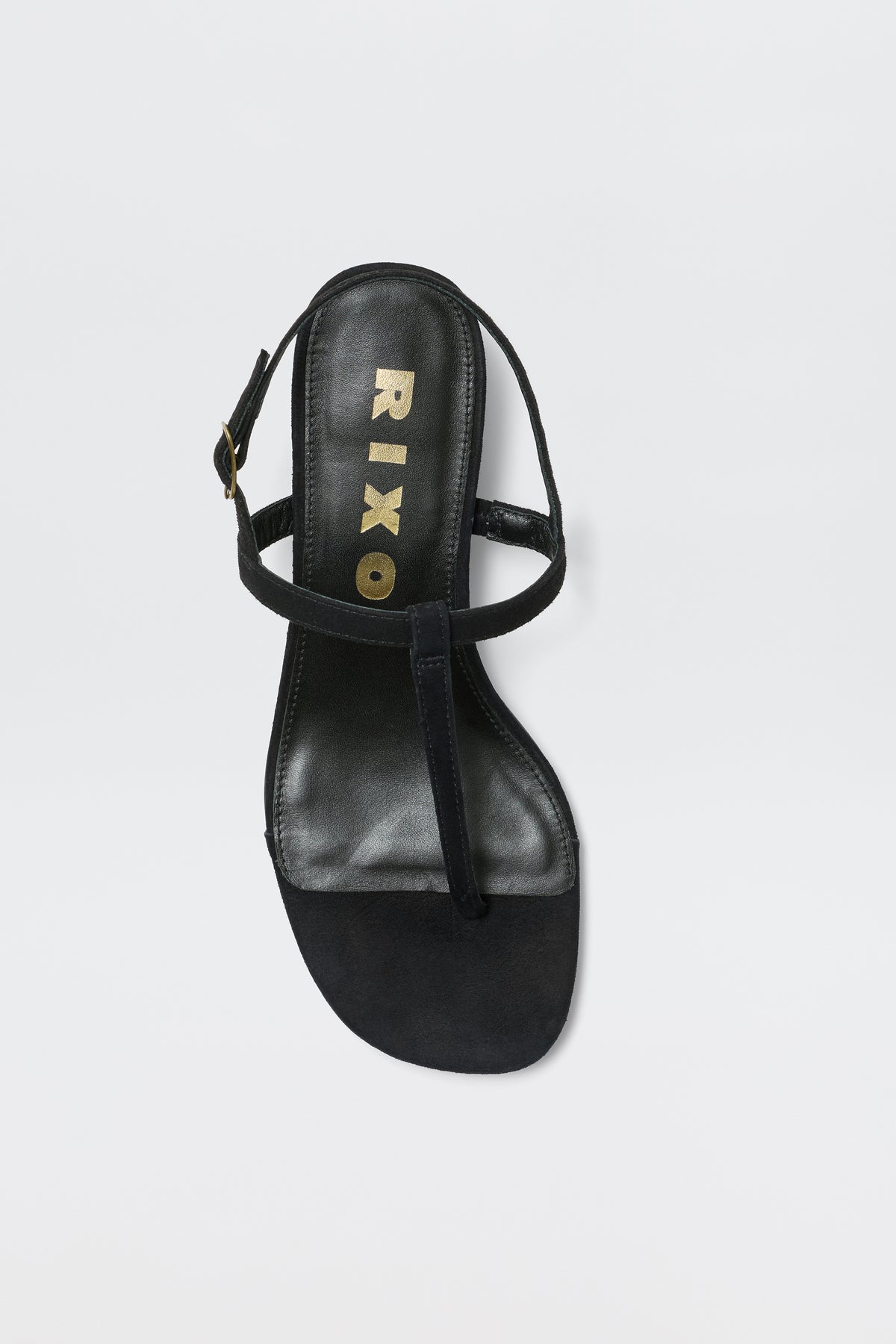 The Mads - Black sandal features a black T-strap design, a slingback strap with a small buckle, and gold RIXO branding on the insole—an elegant touch for your favorite looks, shown on a white background.