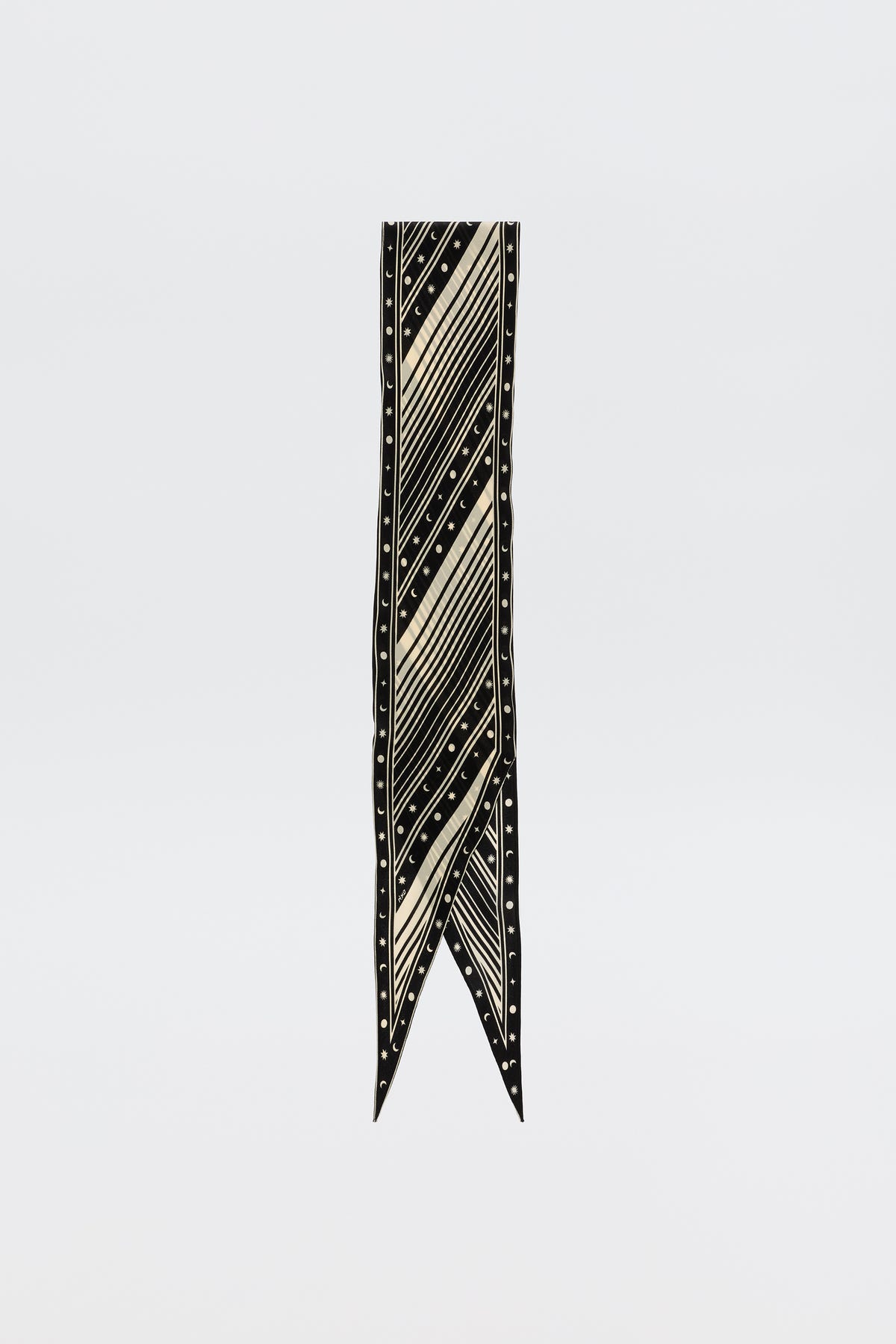 The Nara – Starstruck Black is a long, narrow pure silk scarf with cream diagonal stripes and small dots, finished with a pointed V-shaped tip, shown on a plain white background.