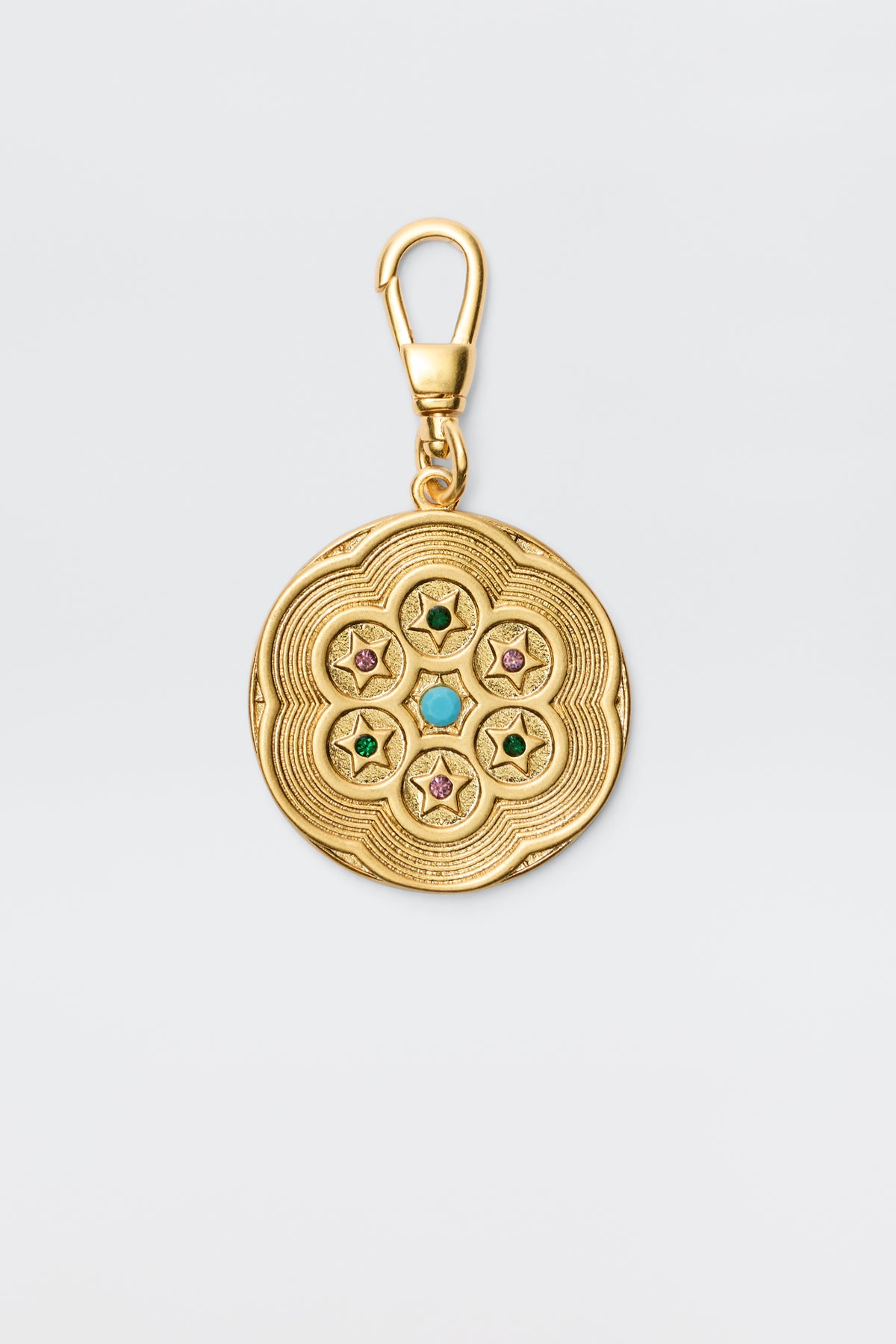 Chelle - Gold is a vintage-finished, gold-plated round charm pendant with engraved patterns and five star motifs set with colorful green, turquoise, or pink gems, secured by a swivel clasp.
