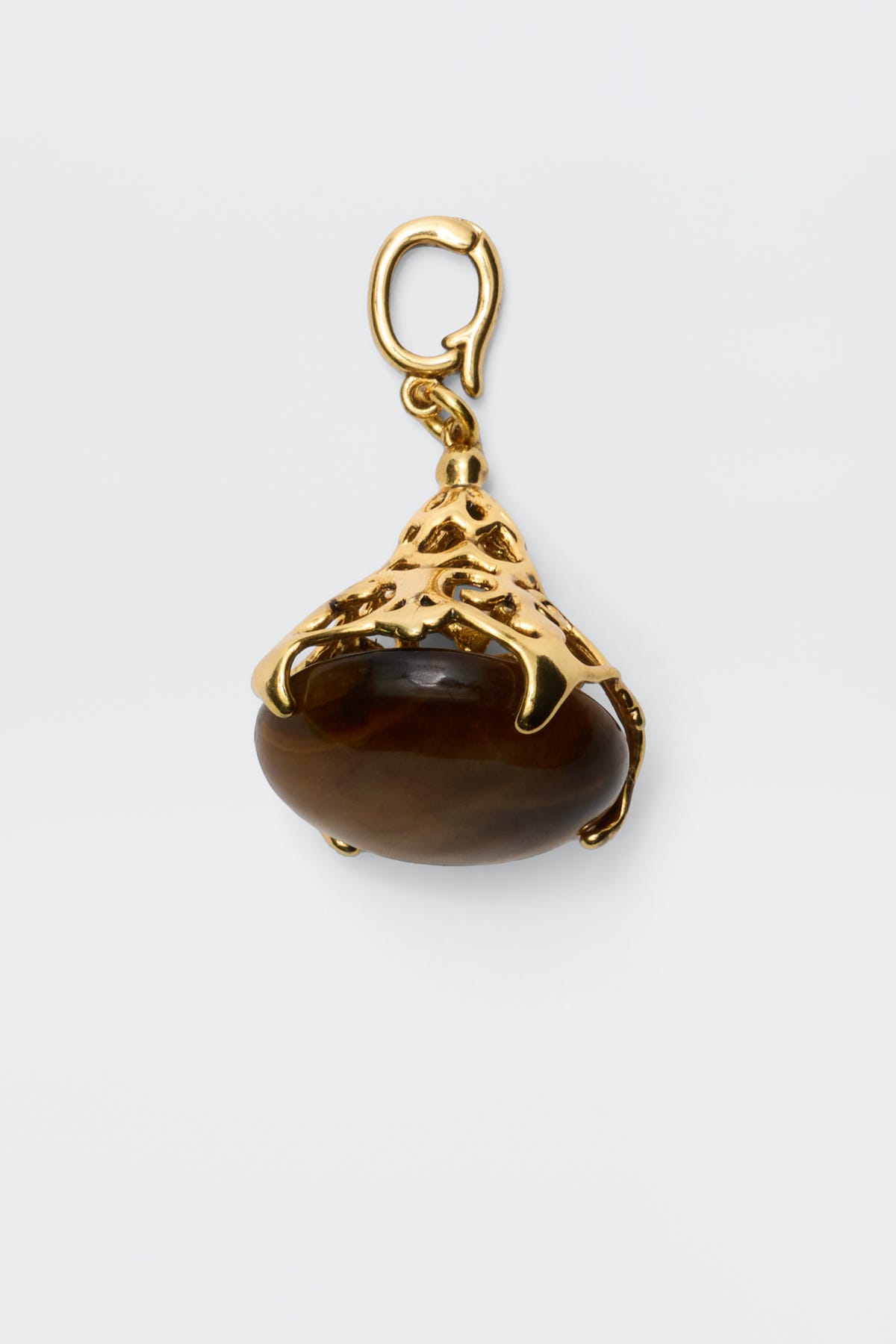 The Maella - Gold pendant features a brown oval tiger's eye stone set in an ornate 18K gold-plated setting with a top loop for necklace attachment, shown against a plain white background.