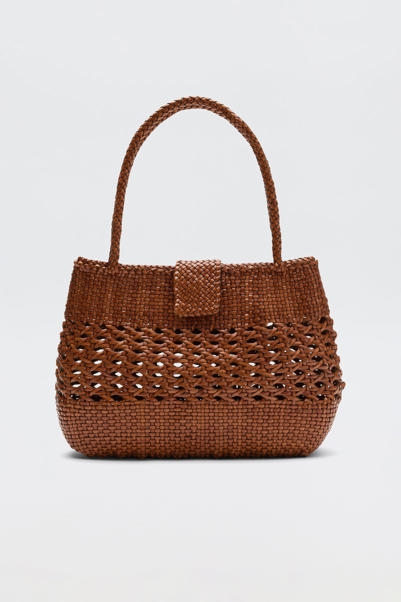 The Niamh - Tan by Dragon Diffusion features a single top handle, flap closure, and textured design in brown, elegantly displayed on a white background—a stylish take on vintage woven bags.