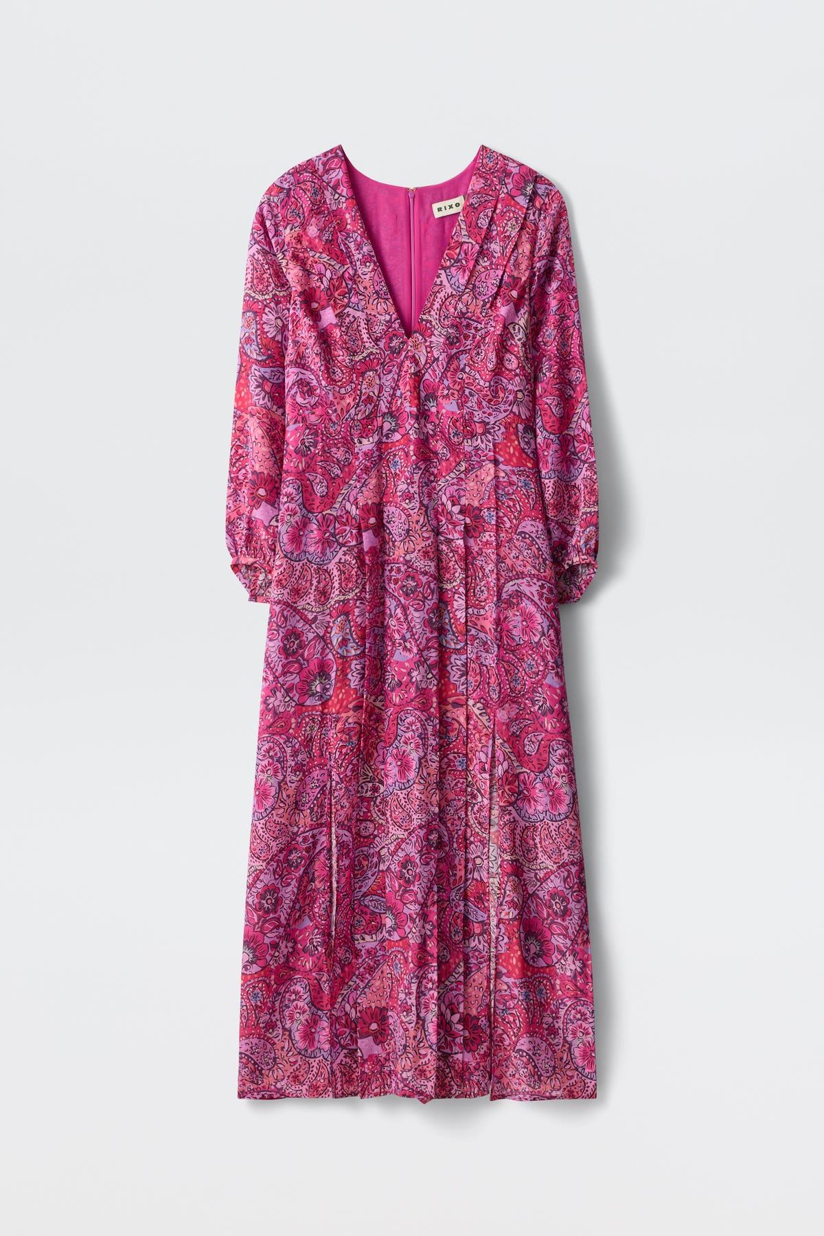 The Camellia - Paisley Floral Red is an ankle-length, long-sleeved dress featuring a vibrant pink and purple paisley pattern, V-neckline, and pleated skirt, shown on a plain white background.