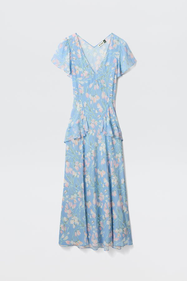 The Evie - Watercolour Floral Blue is a light blue, V-neck dress with short sleeves, a pastel floral print, ruffled hip detail, fitted waist, and an ankle-length flowing skirt.