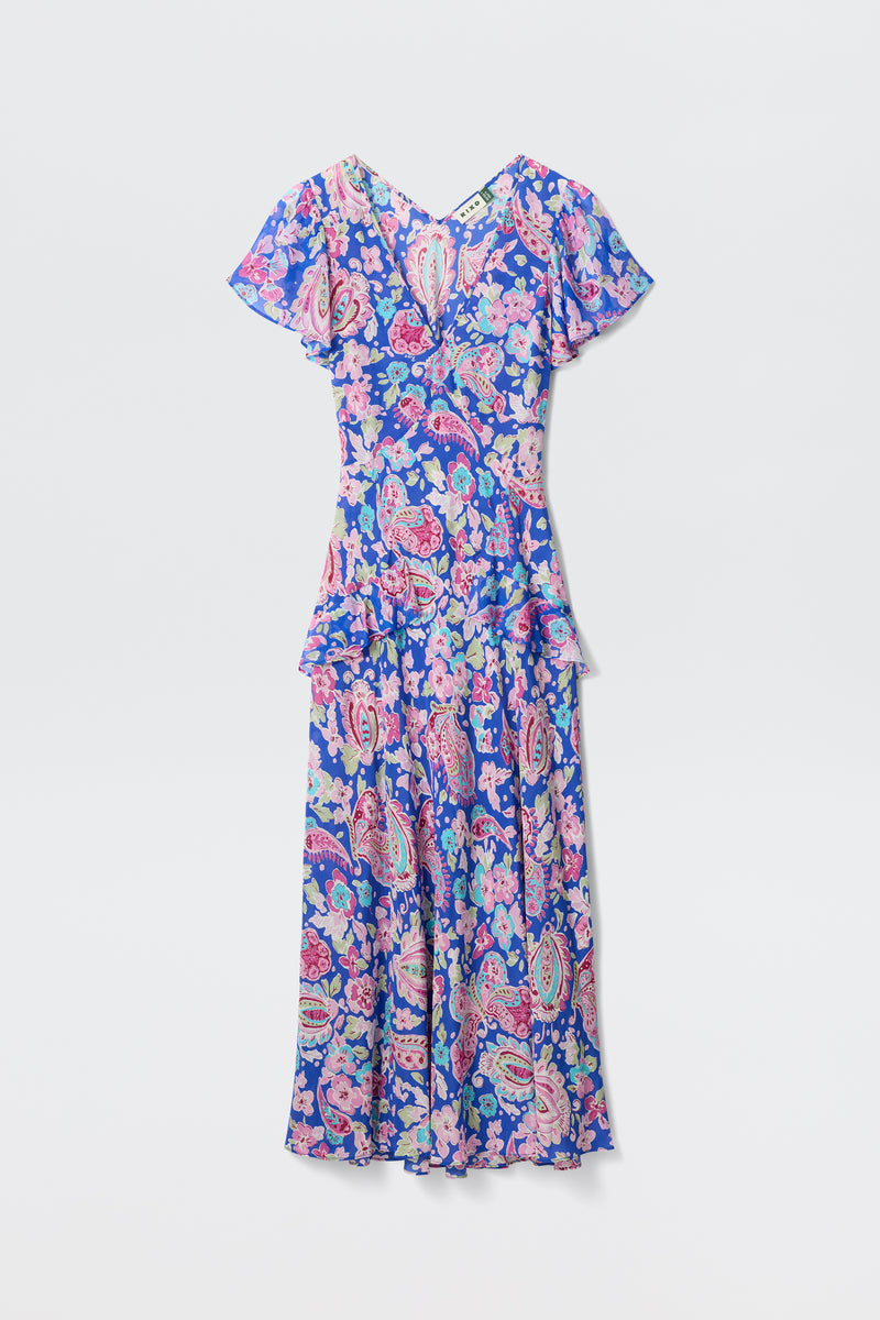 The Evie - Cara Floral Blue is an ankle-length dress featuring short flutter sleeves and a floral paisley print in blue, pink, and purple, shown against a plain white background.