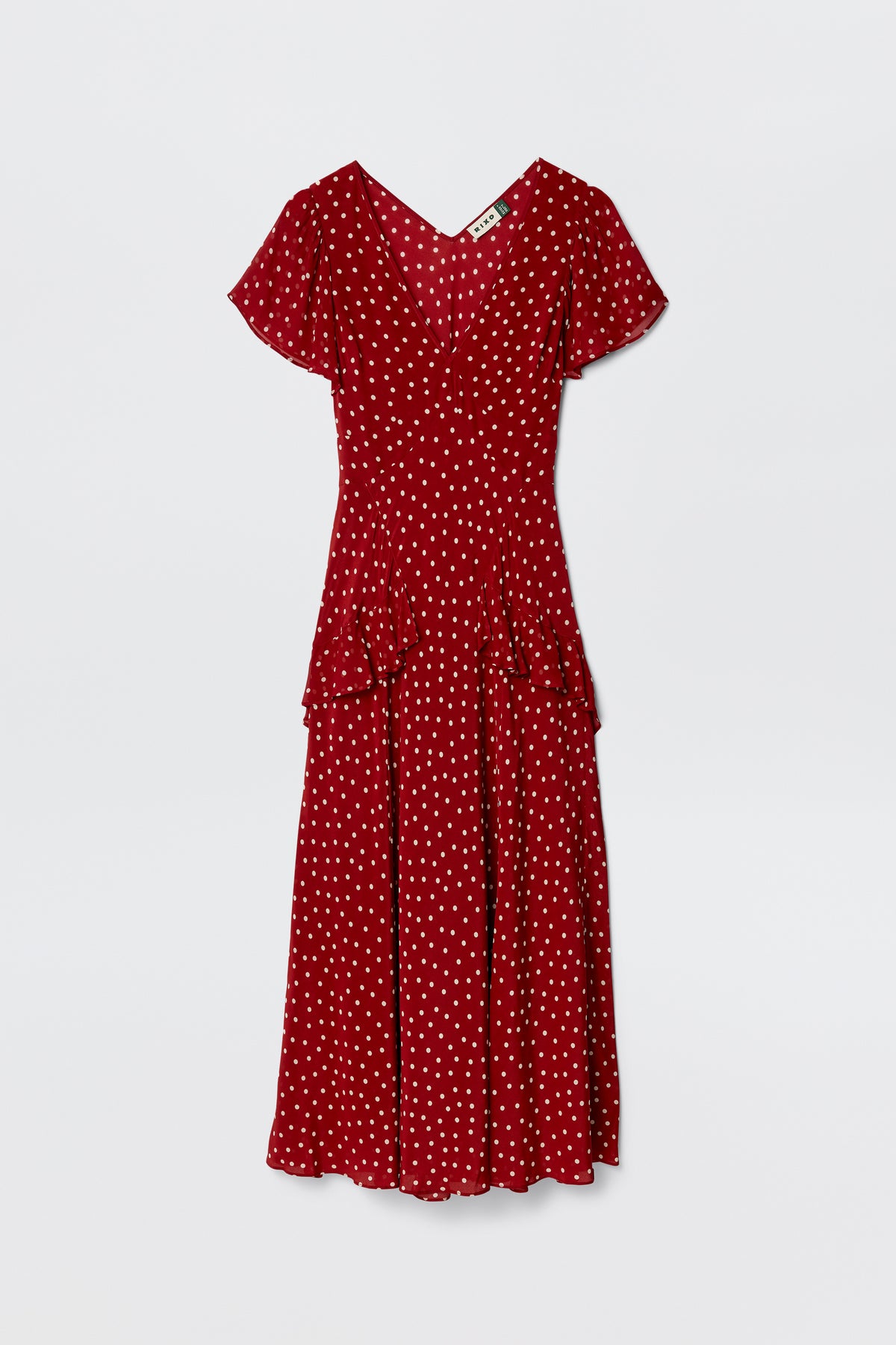 The Evie - Layla Dot Red dress, a red silk Crepe de Chine piece by RIXO, features polka dots, short sleeves, a V-neckline, fitted bodice, flared skirt, and waist ruffle detail, shown against a plain white background.