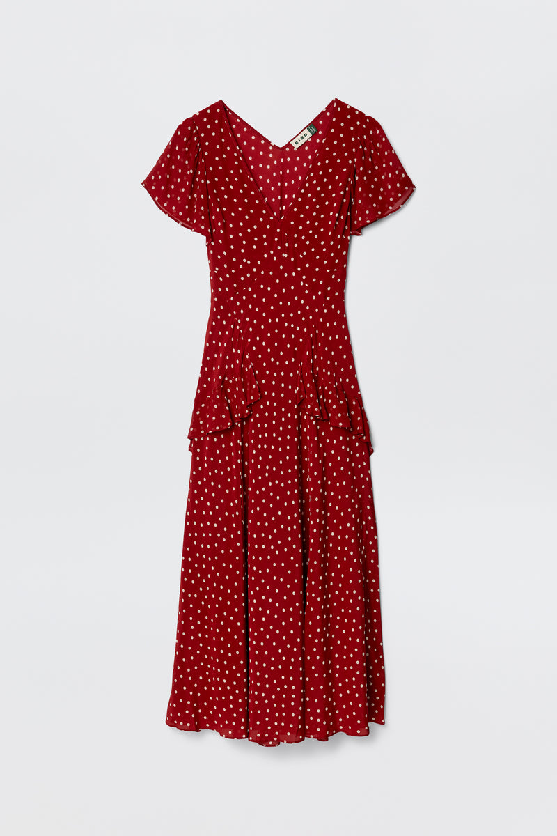 The Evie - Layla Dot Red dress, a red silk Crepe de Chine piece by RIXO, features polka dots, short sleeves, a V-neckline, fitted bodice, flared skirt, and waist ruffle detail, shown against a plain white background.
