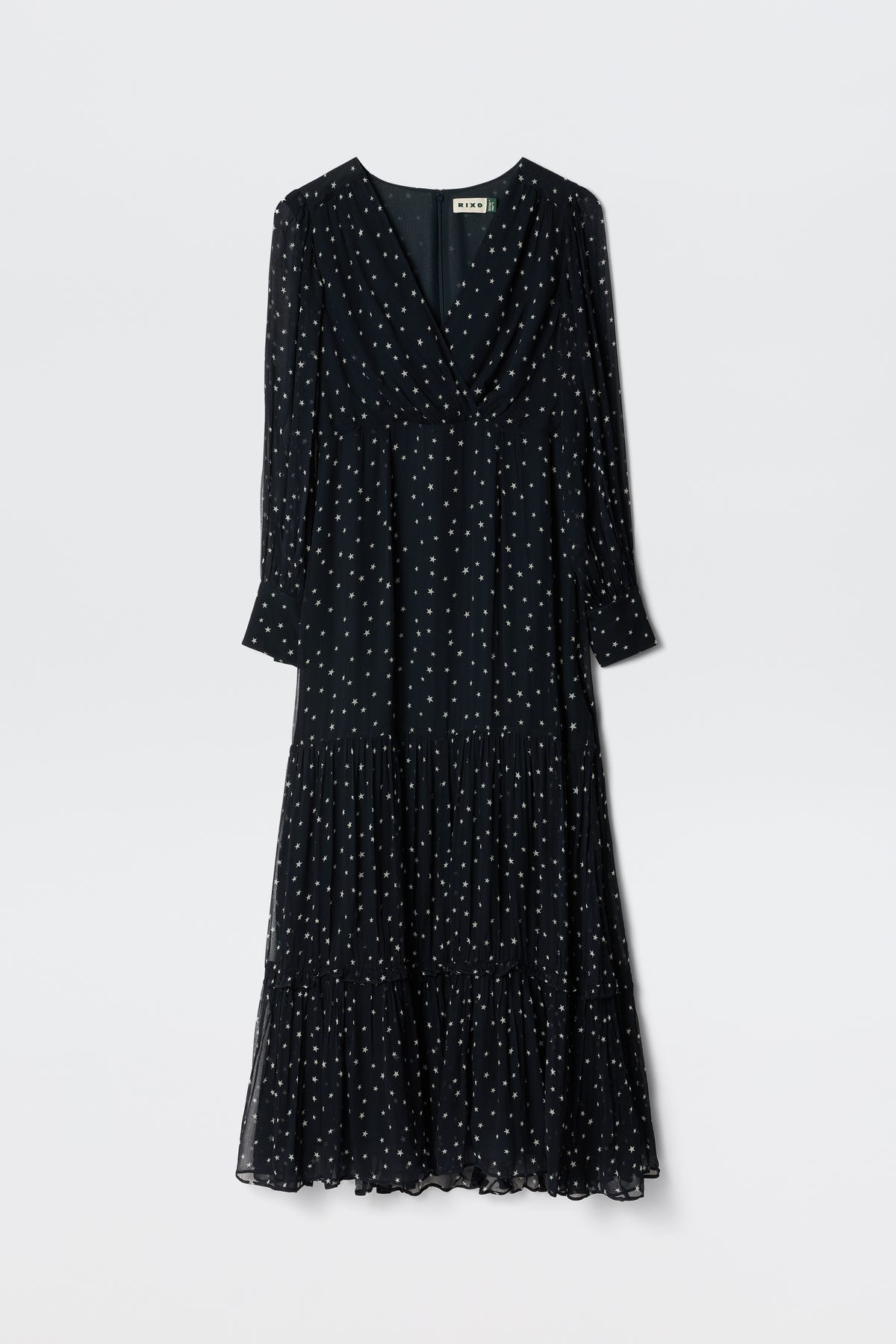 The Elsie - Starry Night Navy is an ankle-length, long-sleeved dress with a V-neckline, white polka dots, tiered skirt, and lightweight fabric for effortless comfort.