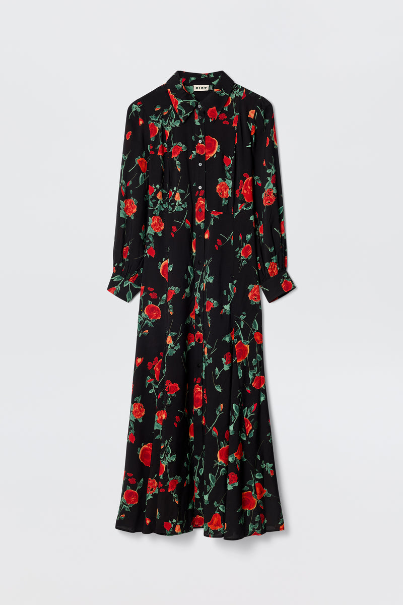 The Maddison - Claudia Rose Black is a long-sleeved, collared black maxi shirt dress with a button-down front and vibrant red rose print—ideal for petite frames and everyday chic style.
