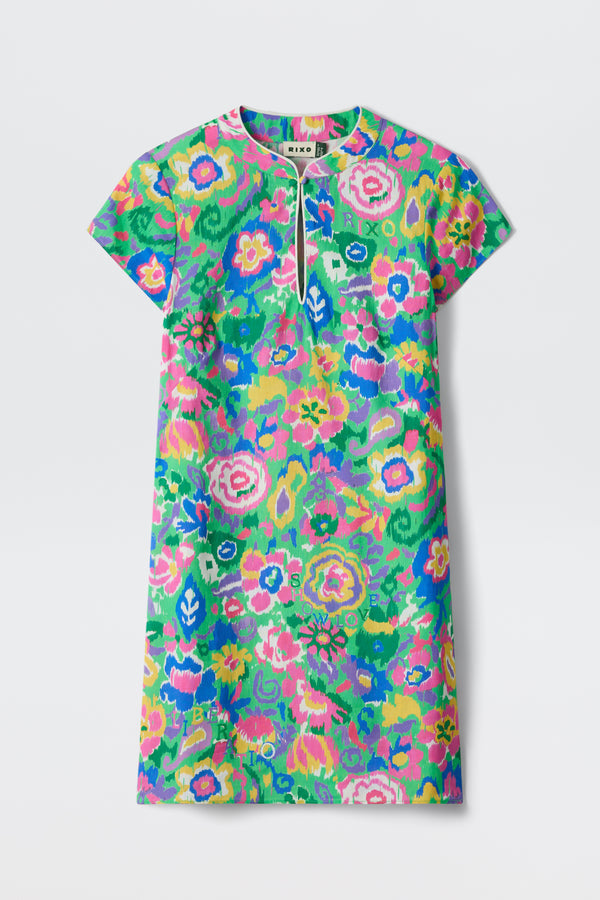 The Lolita - Ikat Bloom Green is a short-sleeve dress with a vibrant, multicolor floral pattern in pink, green, blue, and yellow, and features a small keyhole neckline.