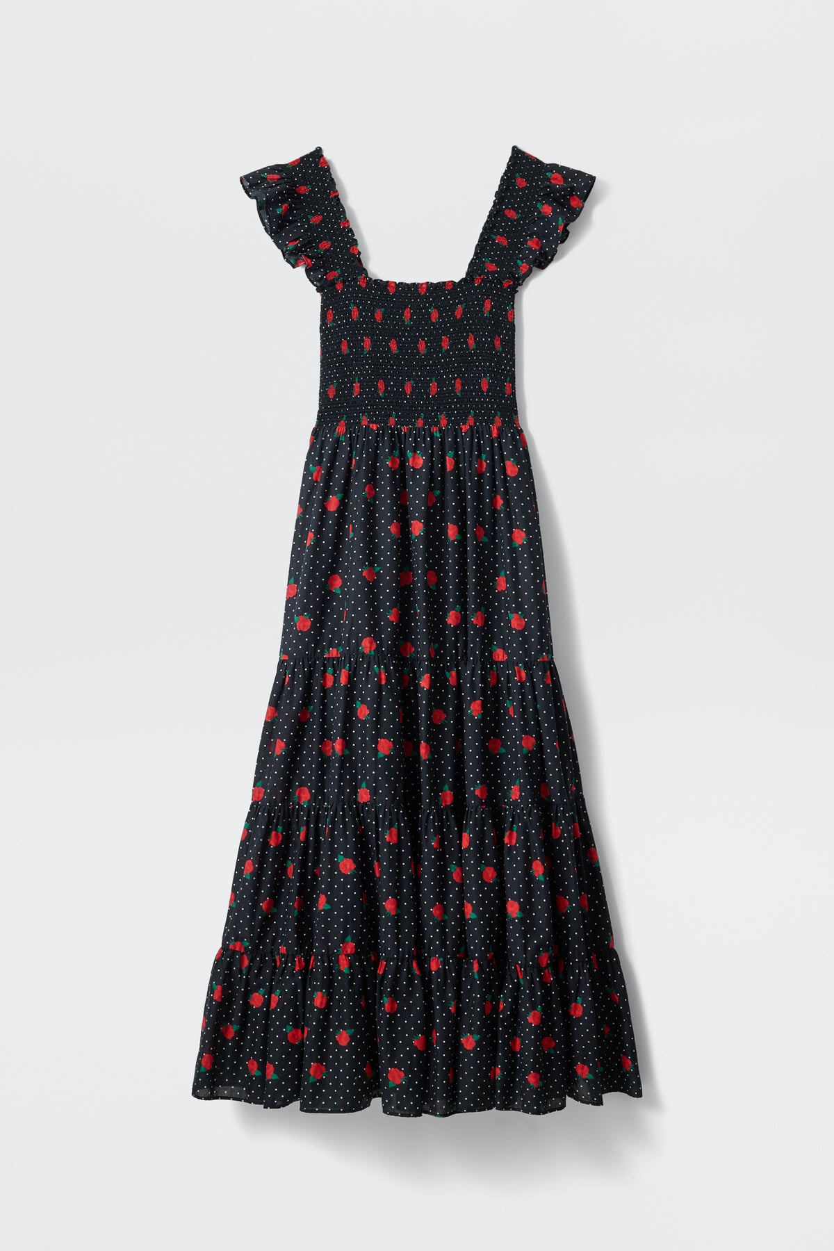 The Kendall - Rose Spot Black is a sleeveless long black dress with a tiered skirt, ruffled shoulder straps, and a pattern of small red flowers and white dots.
