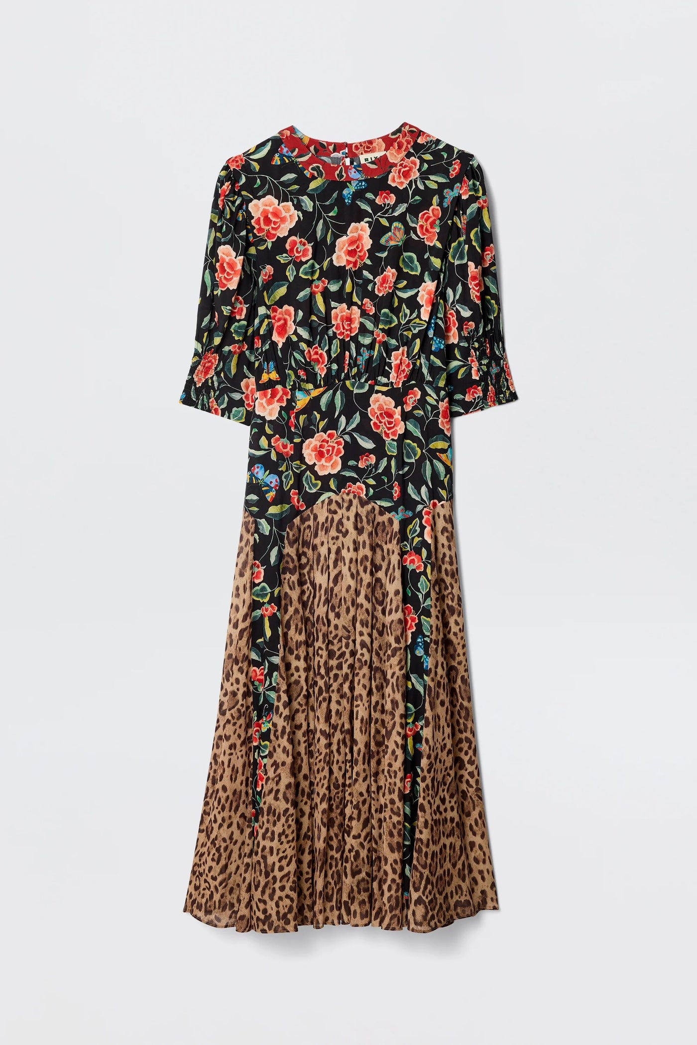 The Meg - Mila Butterfly Mix Black is a long-sleeved dress with a fitted floral top in red and yellow on black and a pleated leopard print skirt, creating striking, contrasting patterns ideal for relaxed everyday wear.
