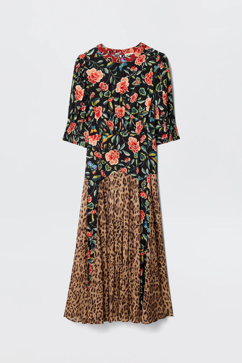 The Meg - Mila Butterfly Mix Black is a long-sleeved dress with a fitted floral top in red and yellow on black and a pleated leopard print skirt, creating striking, contrasting patterns ideal for relaxed everyday wear.