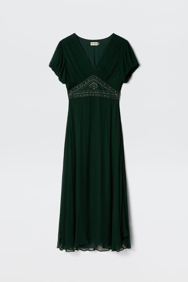 The Corrine - Diana Embellishment Forest Green is a dark green, short-sleeve V-neck midi dress featuring a flowing skirt and bead embellishments below the bust, shown on a white background.