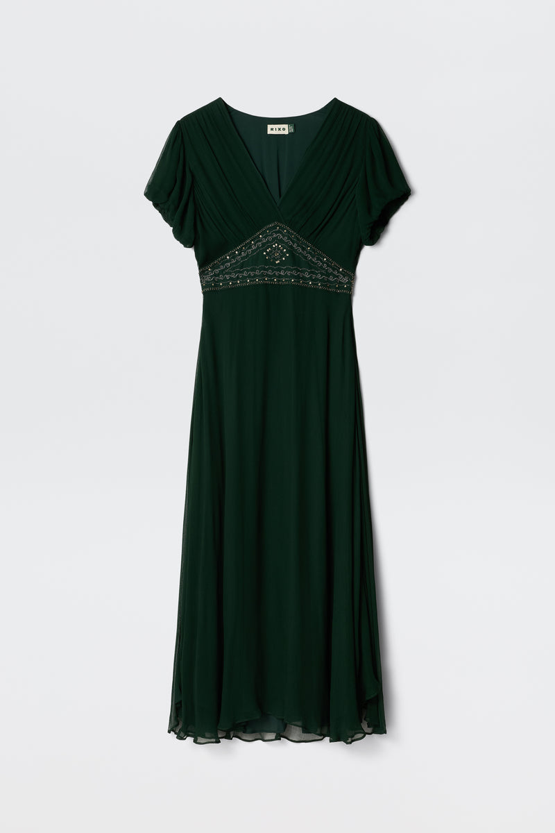 The Corrine - Diana Embellishment Forest Green is a dark green, short-sleeve V-neck midi dress featuring a flowing skirt and bead embellishments below the bust, shown on a white background.