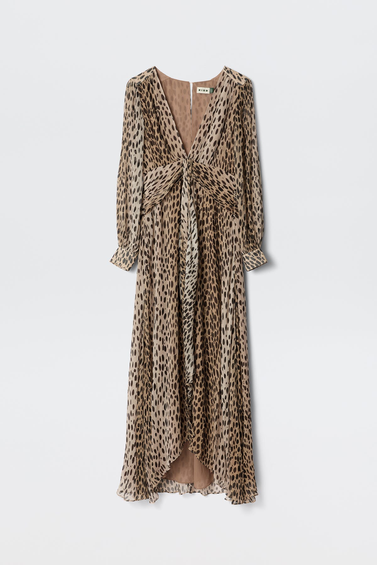 The Meera - Antelope Spot Black gown is a long, flowy dress with a deep V-neckline and long sleeves, crafted from crinkled-chiffon in a brown and black spot print. It features a gathered waist and chic knotted front detail.