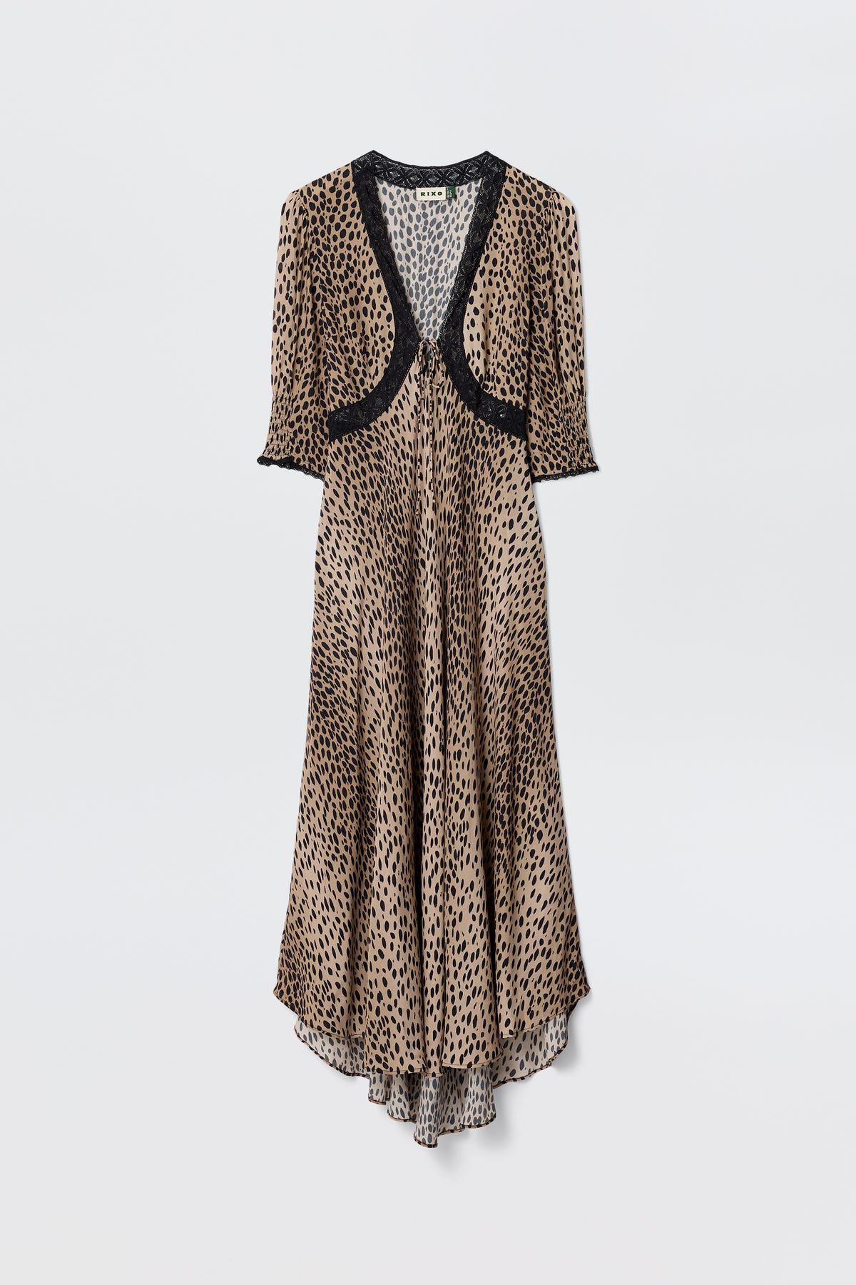 The Amina - Antelope Spot Black dress features a long, flowing silhouette with short sleeves and black lace trims at the neckline, sleeves, and chest, showcasing a brown and black leopard print on a plain white background.