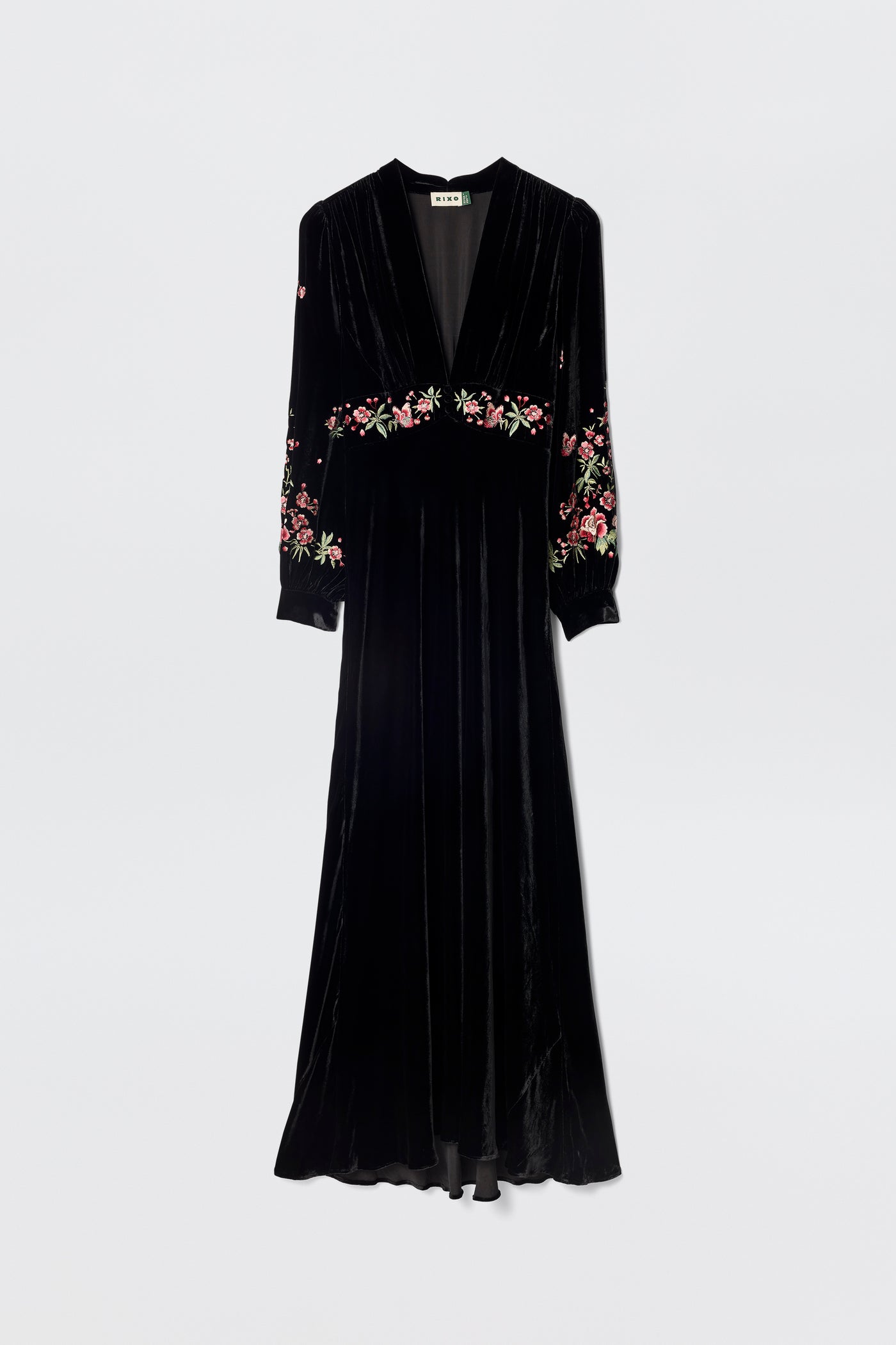 The Emory - Blossom Embroidery Pink is a 1930s-inspired black velvet gown with long sleeves, a V-neckline, and pink floral embroidery on the sleeves and waist, shown against a plain white background.