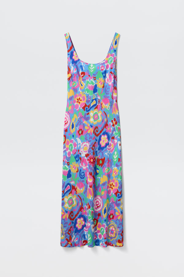 The Bondi - Ikat Bloom Lilac is a sleeveless, ankle-length dress featuring a colorful floral pattern in blue, pink, yellow, green, and red hues, displayed on a plain white background.