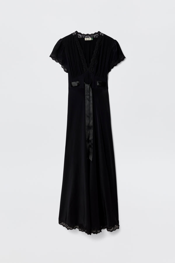 The Marlice - Black is a long black dress with short sleeves, lace trim on the neckline, sleeves, and hem, plus a satin bow sash at the waist—an elegant choice for your collection—shown against a plain white background.