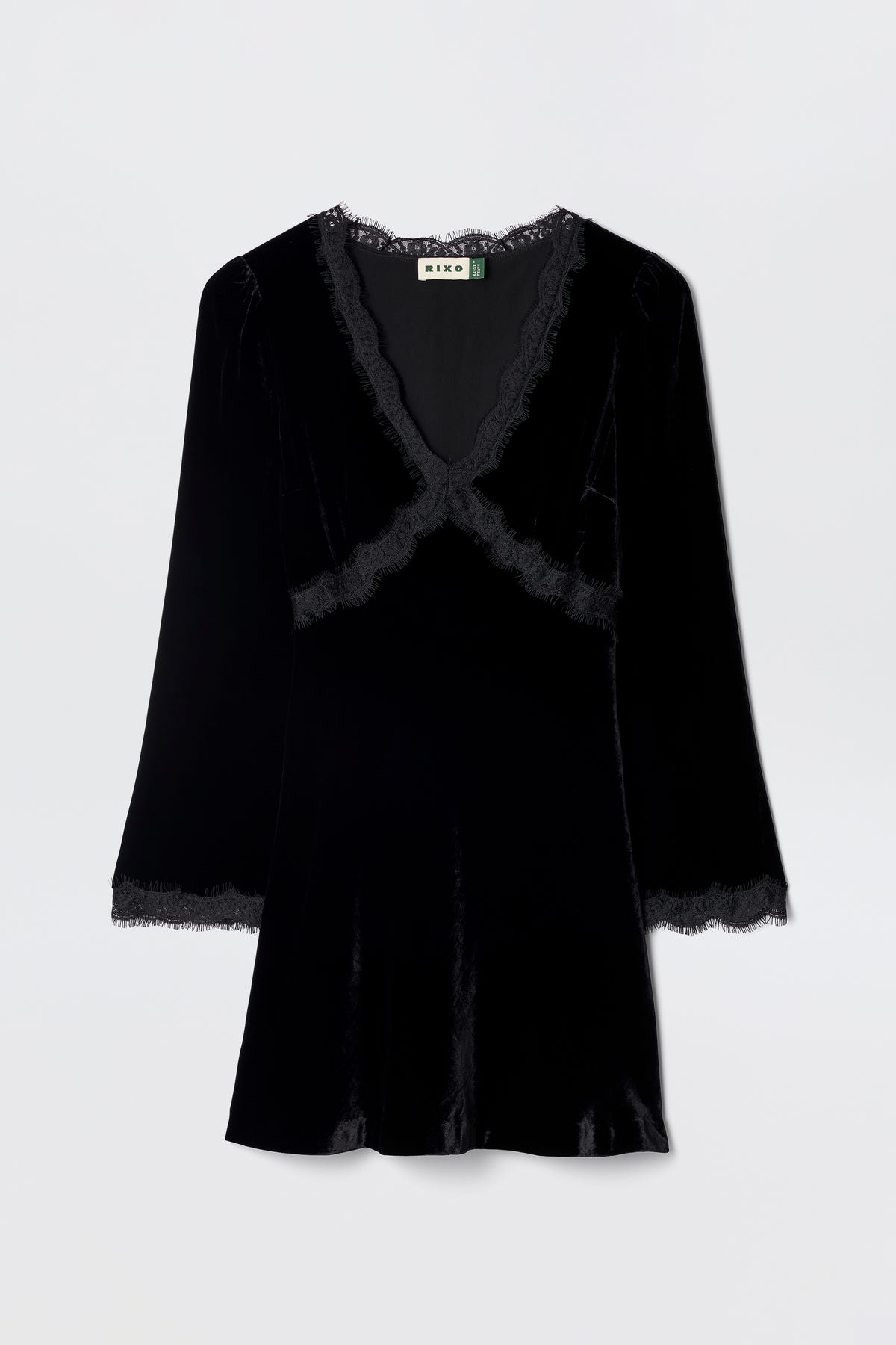 The Macie - Black dress is a velvet little black dress with long sleeves, a V-neckline, and lace trim at the neckline, cuffs, and hem, shown against a plain light background.