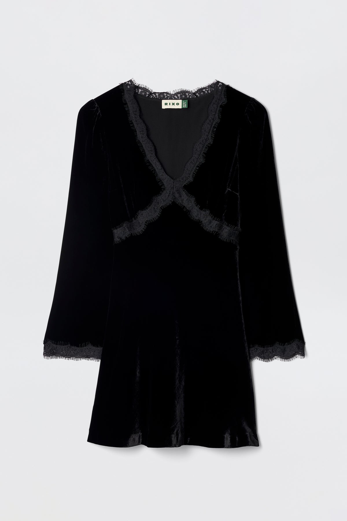 The Macie - Black dress is a velvet little black dress with long sleeves, a V-neckline, and lace trim at the neckline, cuffs, and hem, shown against a plain light background.