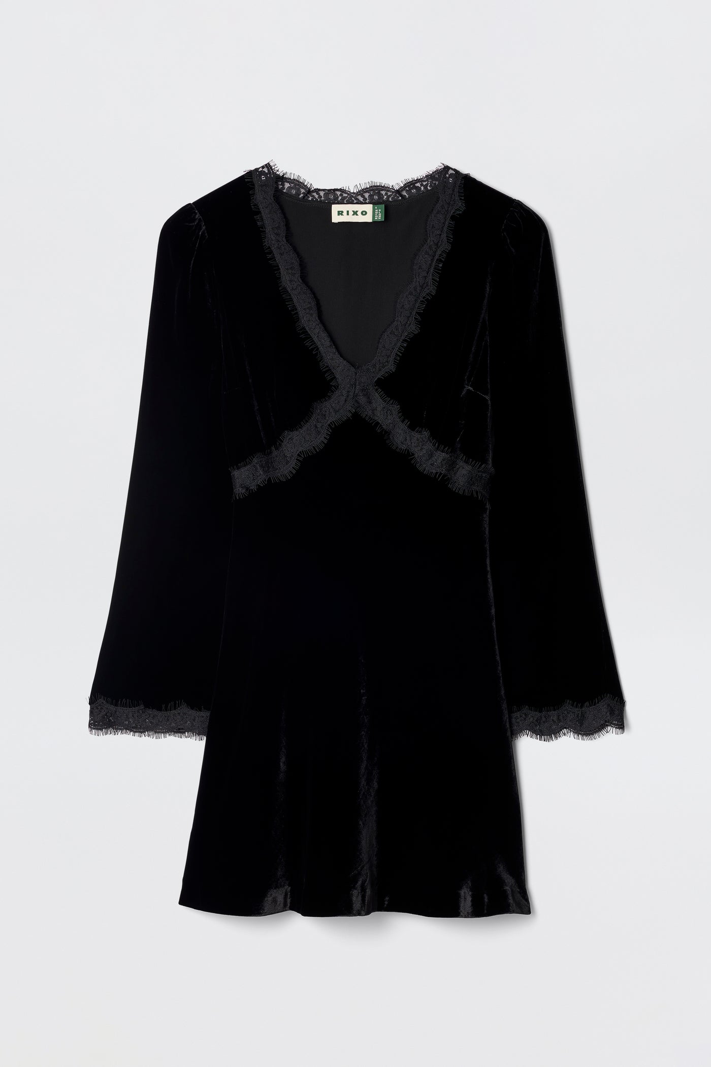 The Macie - Black dress is a velvet little black dress with long sleeves, a V-neckline, and lace trim at the neckline, cuffs, and hem, shown against a plain light background.