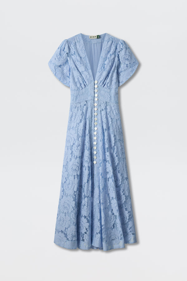 Novara - Vintage Blue is a vintage-inspired, light blue maxi dress with short sleeves, cotton-blend lace, a V-neckline, white front buttons, floral pattern, and fitted waist for a flowy, elegant silhouette.