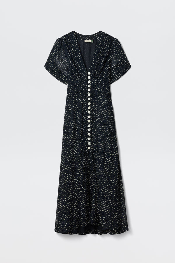 The Novara - Painted Spot Midnight Navy dress features short sleeves, a v-neckline, white polka dots, and large white front buttons for vintage charm.