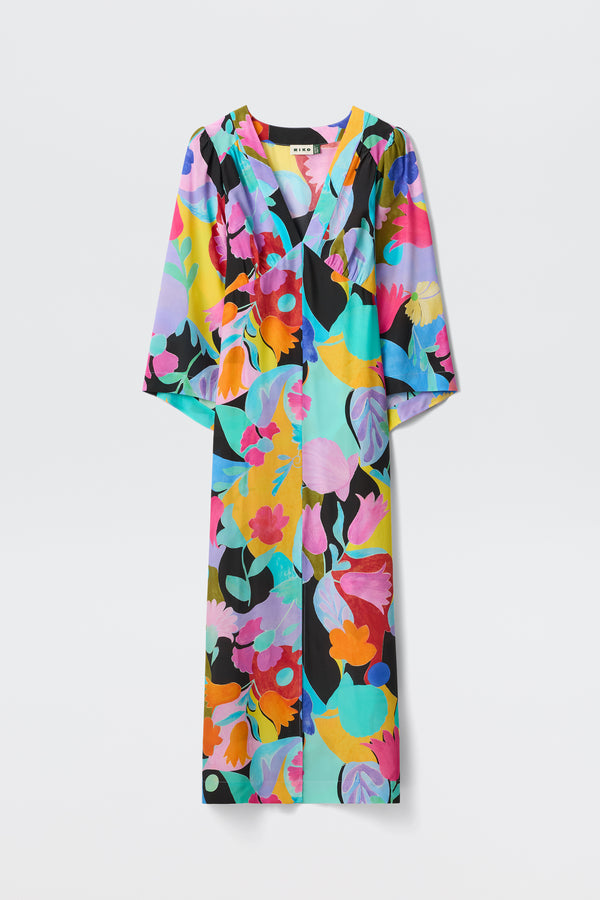 The Dahlia - Abstract Tulip Black is a long-sleeved V-neck dress with dramatic sleeves, featuring a bold, colorful floral print in pink, yellow, blue, purple, and green on a light background.