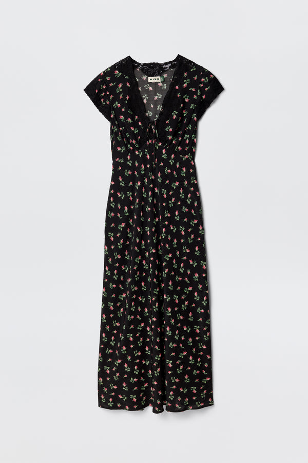 The Amari - Sienna Bud Black is a black bias-cut dress with short sleeves, a V-neckline, and a red and green Sienna Bud print. Its relaxed fit and lightweight fabric offer effortless elegance.