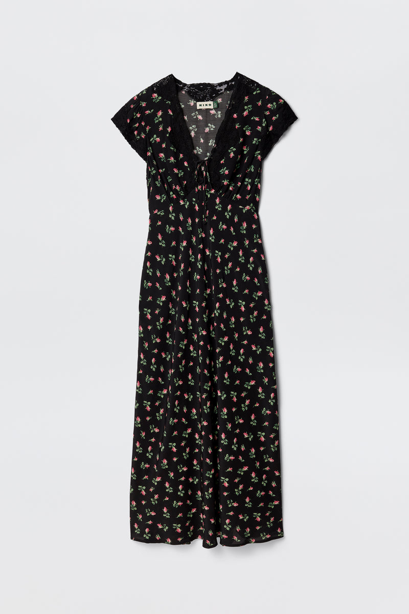 The Amari - Sienna Bud Black is a black bias-cut dress with short sleeves, a V-neckline, and a red and green Sienna Bud print. Its relaxed fit and lightweight fabric offer effortless elegance.