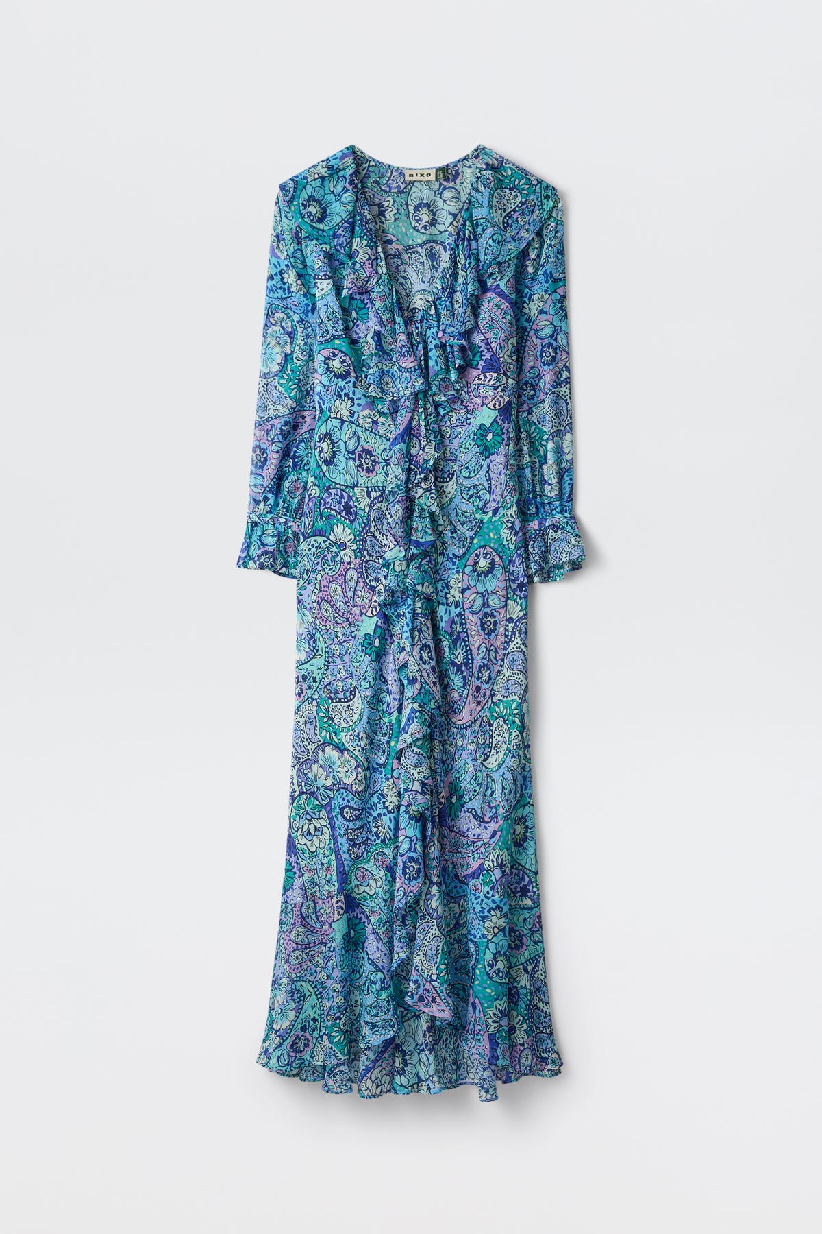 The Gracye - Paisley Floral Blue is a long-sleeved, ankle-length dress featuring a blue, green, and purple paisley print, ruffled front, V-neckline, and flared hem, shown against a plain white background.