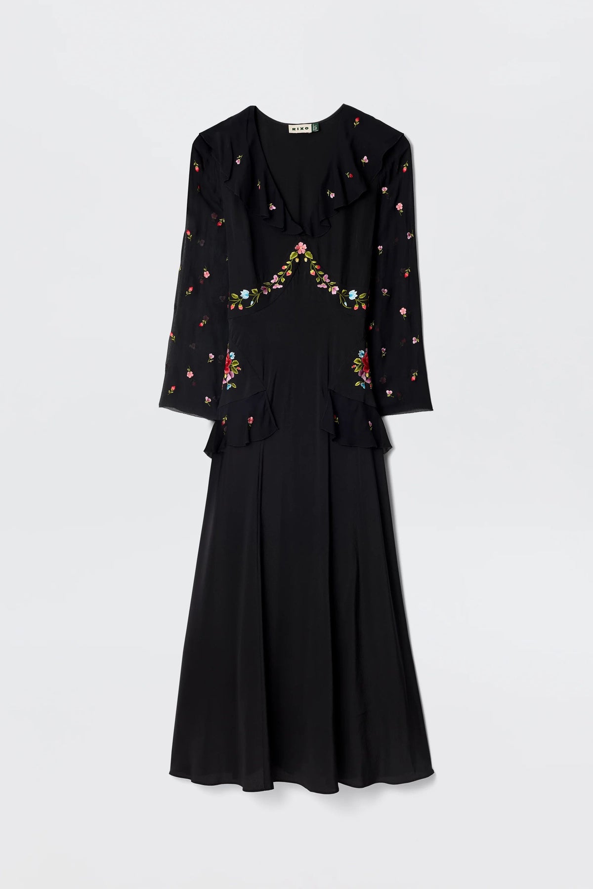The Cedar - Bouquet Embroidery Black is a long-sleeved black silk dress with floral embroidery on the chest, sleeves, and waist, featuring a fitted bodice and flared skirt.