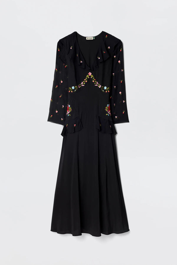 The Cedar - Bouquet Embroidery Black is a long-sleeved black silk dress with floral embroidery on the chest, sleeves, and waist, featuring a fitted bodice and flared skirt.