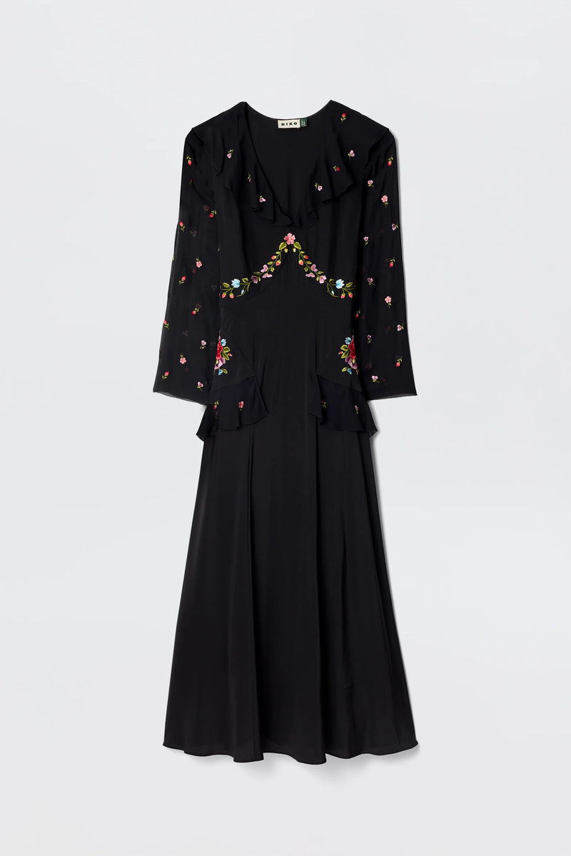 The Cedar - Bouquet Embroidery Black is a long-sleeved black silk dress with floral embroidery on the chest, sleeves, and waist, featuring a fitted bodice and flared skirt.