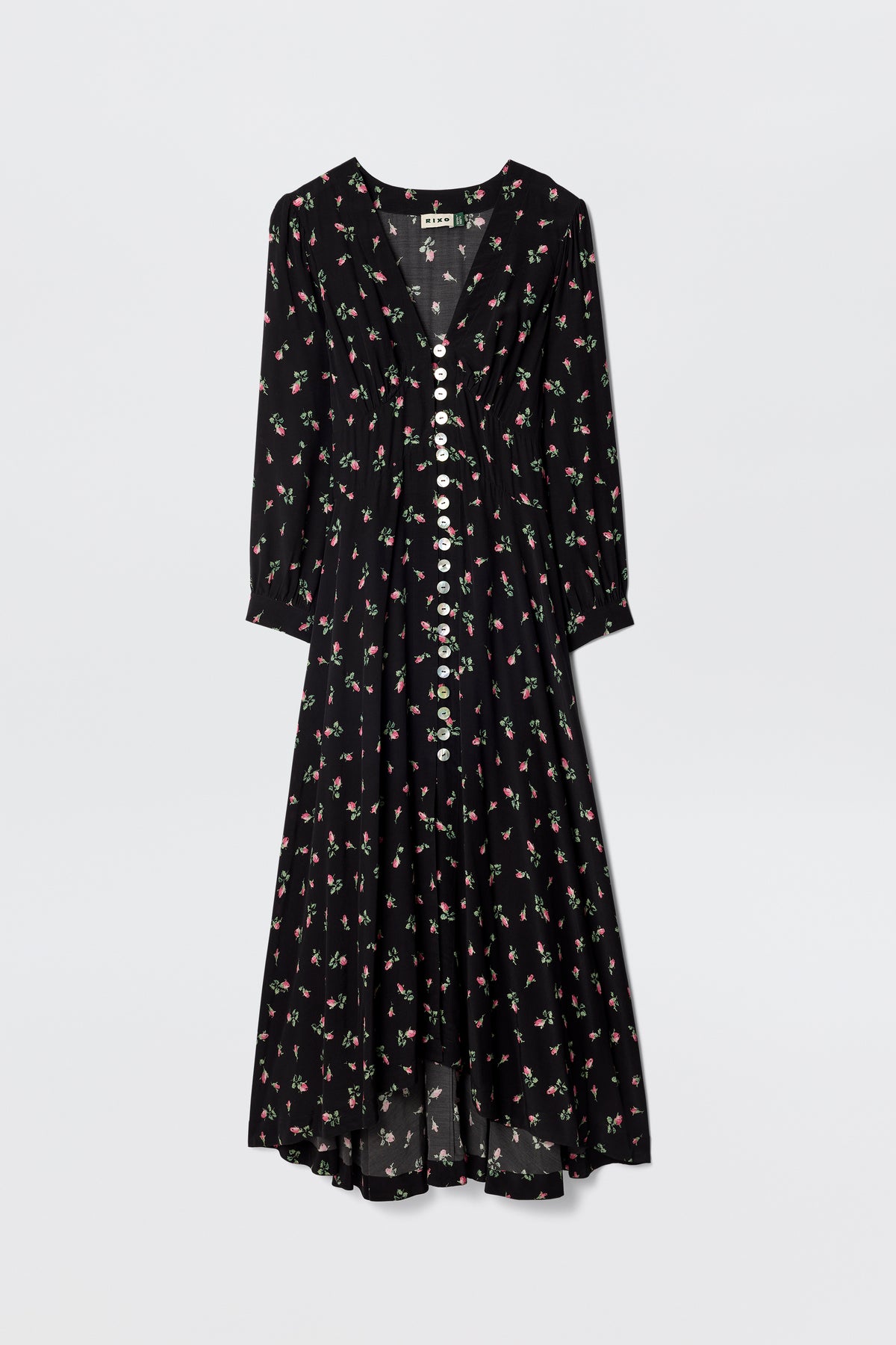 The Avalyn - Sienna Bud Black is a long-sleeved, black silk tea dress with a V-neckline, white buttons, vintage-style cuffs, and a pink and green floral print. Its loose, flowy silhouette offers an elegant, timeless look.