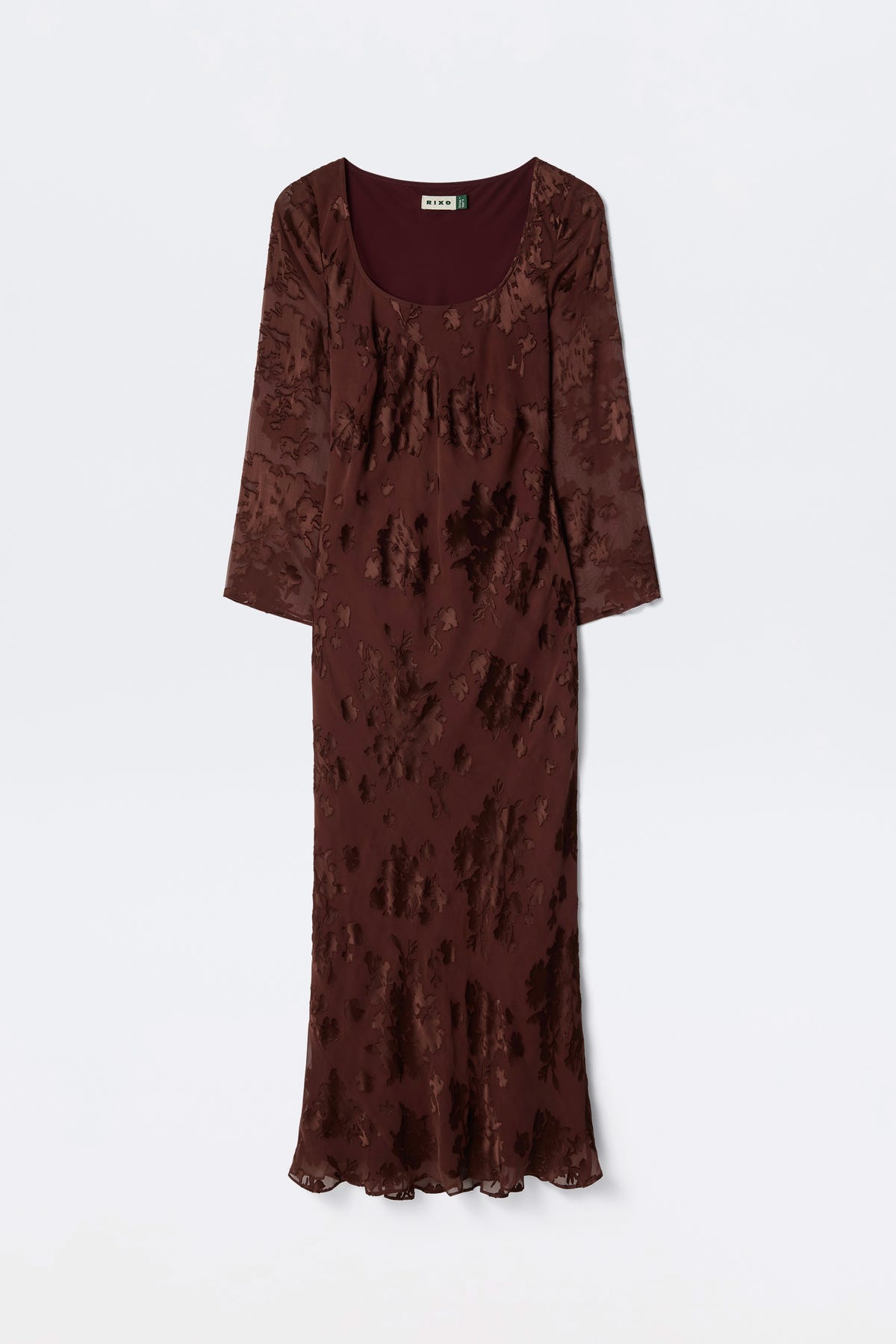 The Noraya - Bouquet Devoré Brown is a long, fitted maroon dress with long sleeves, a scoop neckline, and a subtle textured floral pattern, shown against a plain white background.