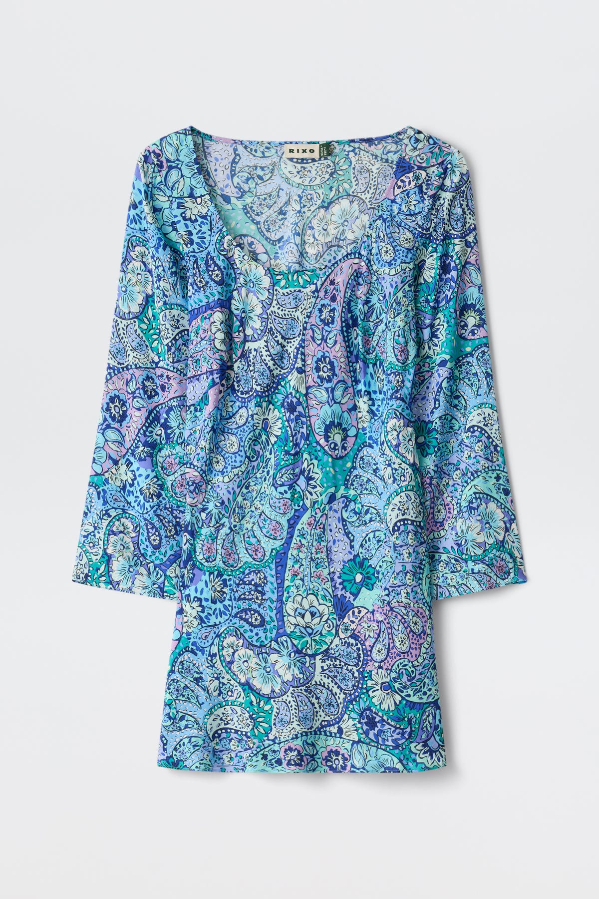 The Dulce - Paisley Floral Blue dress is a long-sleeve, scoop-neck design featuring a blue, teal, and purple paisley pattern, displayed flat against a white background.