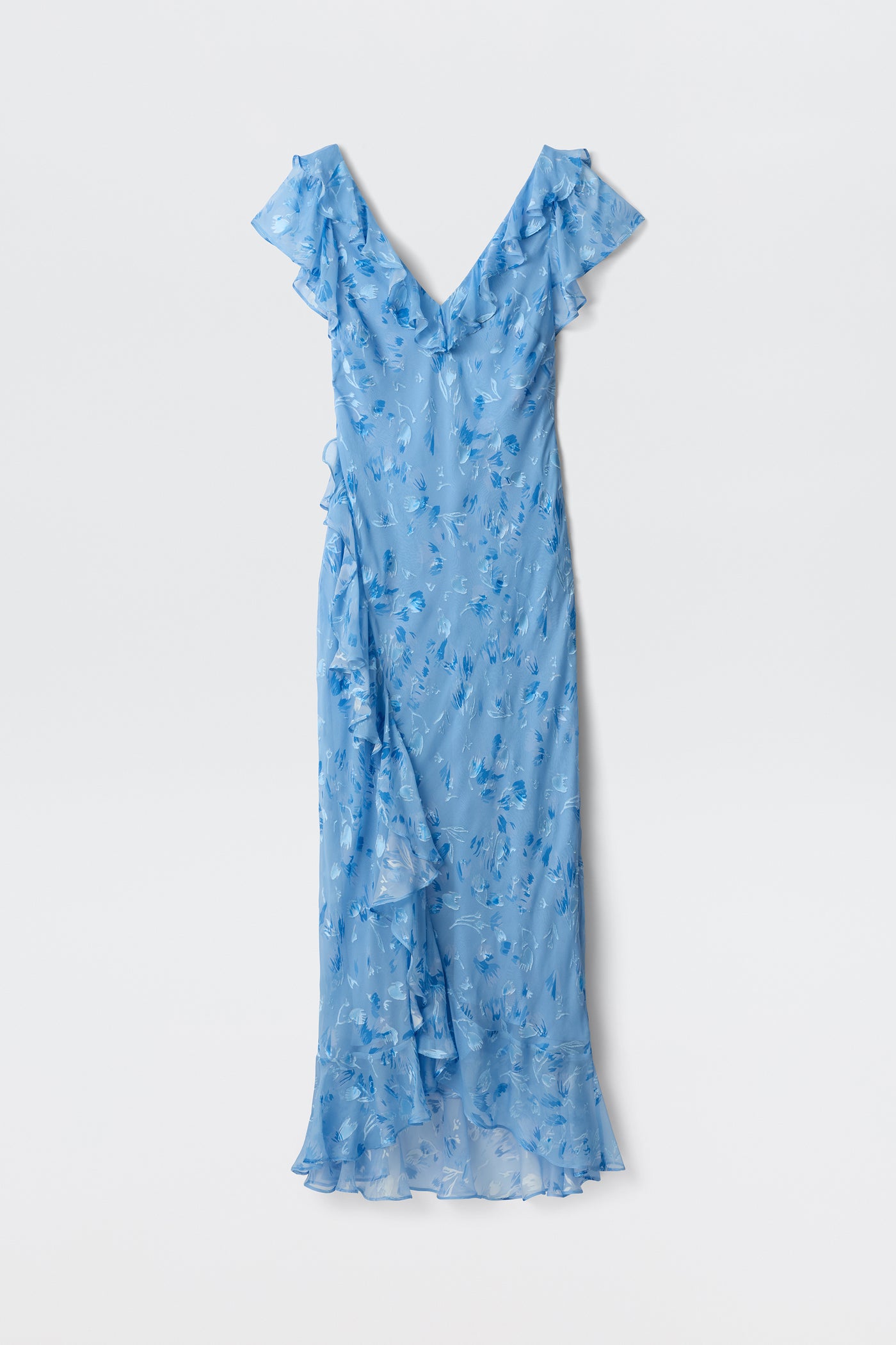 The Meadow - Ava Devore Blue is a sleeveless, light blue maxi dress with ruffles, a V-neckline, and a floral pattern, shown flat on a white background.