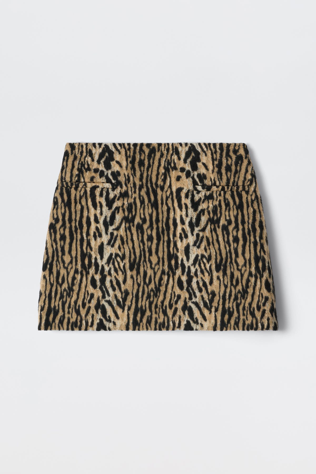 The Mariah - Bohemia Leopard Brown is a high-waisted mini skirt with a bold leopard print in brown, tan, and black, reflecting playful noughties style and shown laid flat on a white background.
