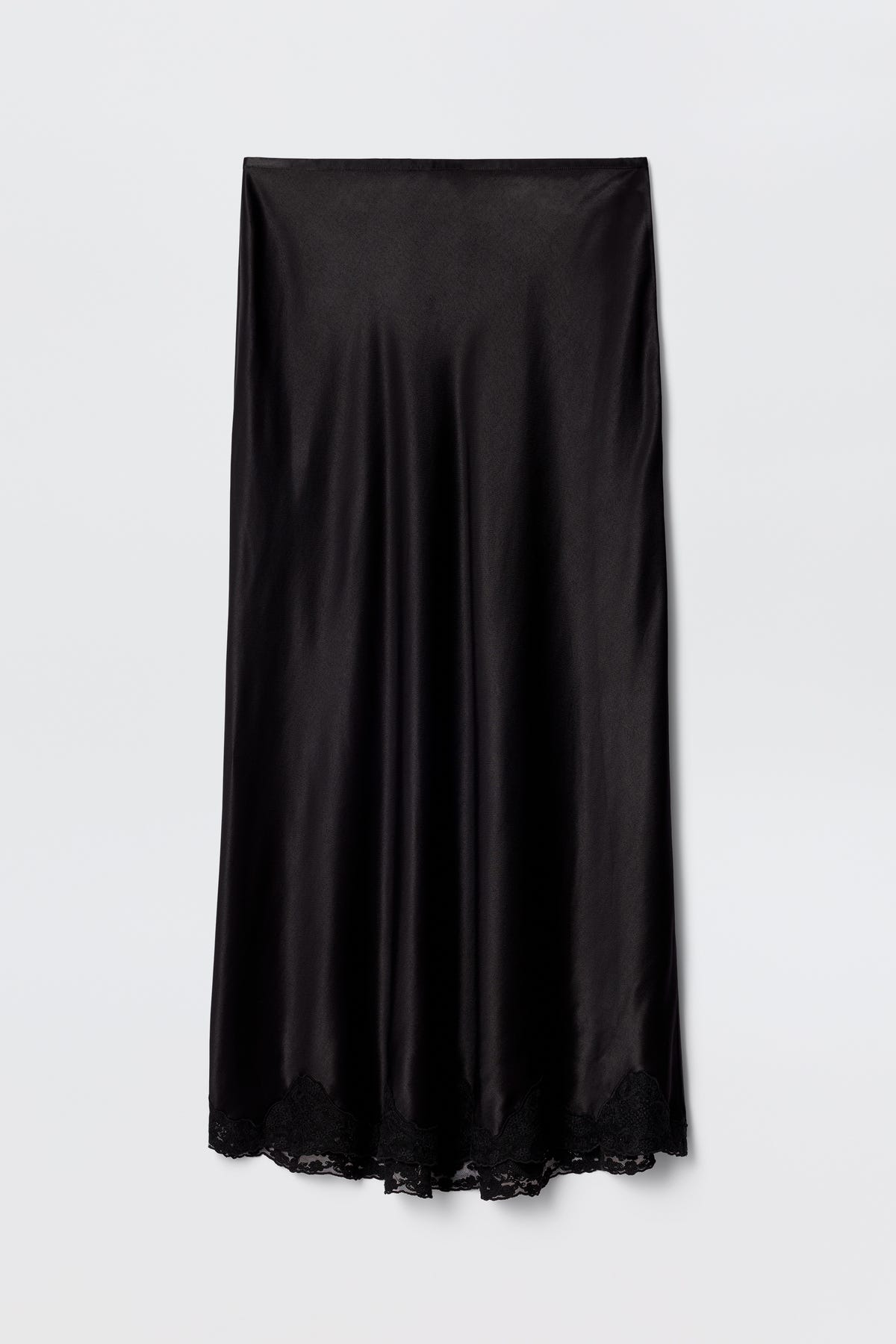 The Crystal - Black is a black satin bias-cut midi skirt with a slight sheen and delicate lace trim at the hem, displayed flat on a plain white background.