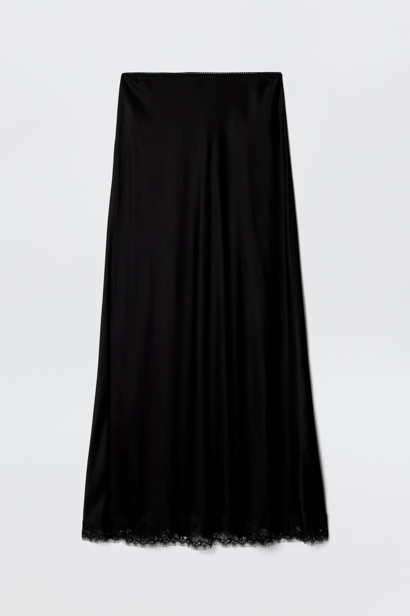The Stassie - Black satin midi slip skirt features a wavy lace hem and is shown against a plain light gray background.