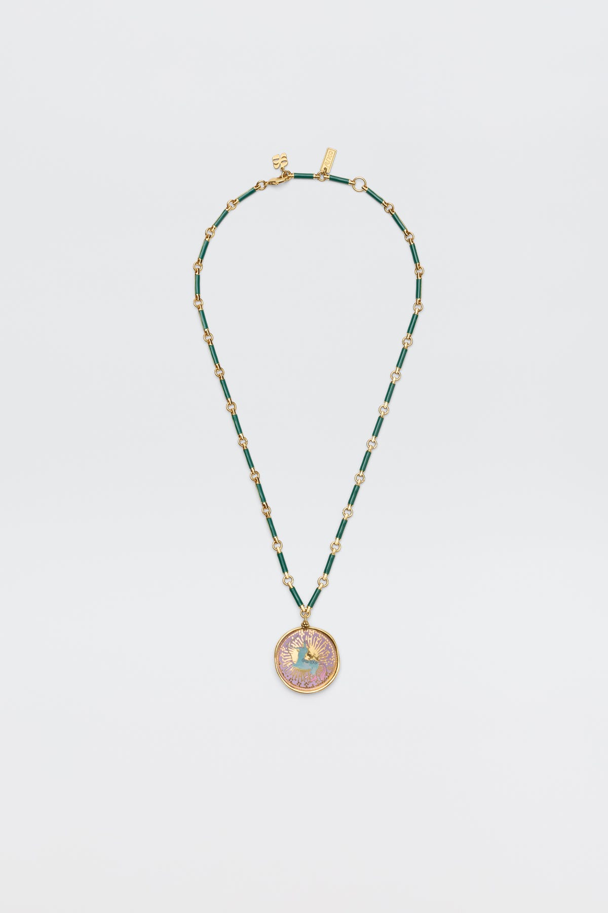 Ari - Astro Sagittarius: A gold and green beaded necklace with an ornate, round pendant featuring an intricate Sagittarius design, shown on a plain white background.