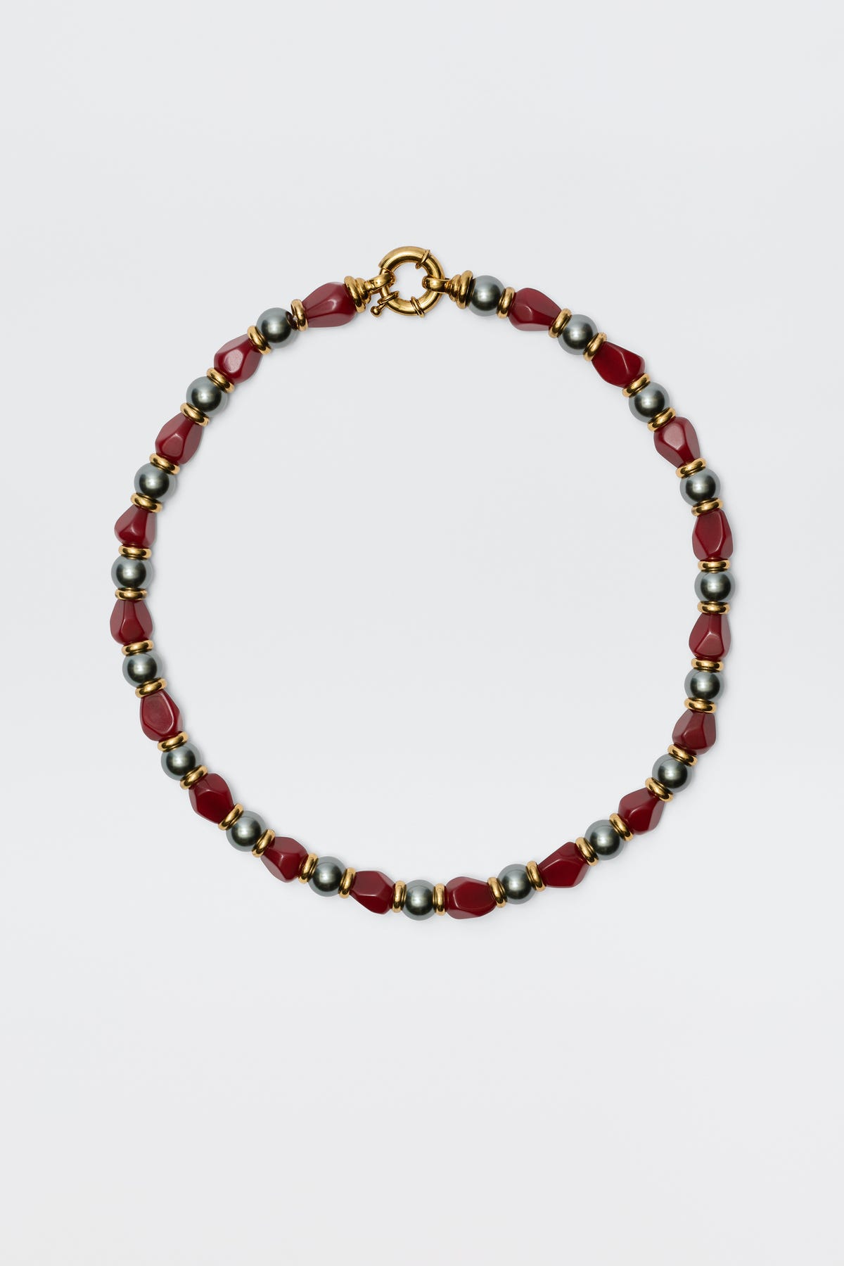 The Palmara - Burgundy necklace features alternating red geometric beads and round metallic silver beads with a gold clasp, showcased on a plain white background.