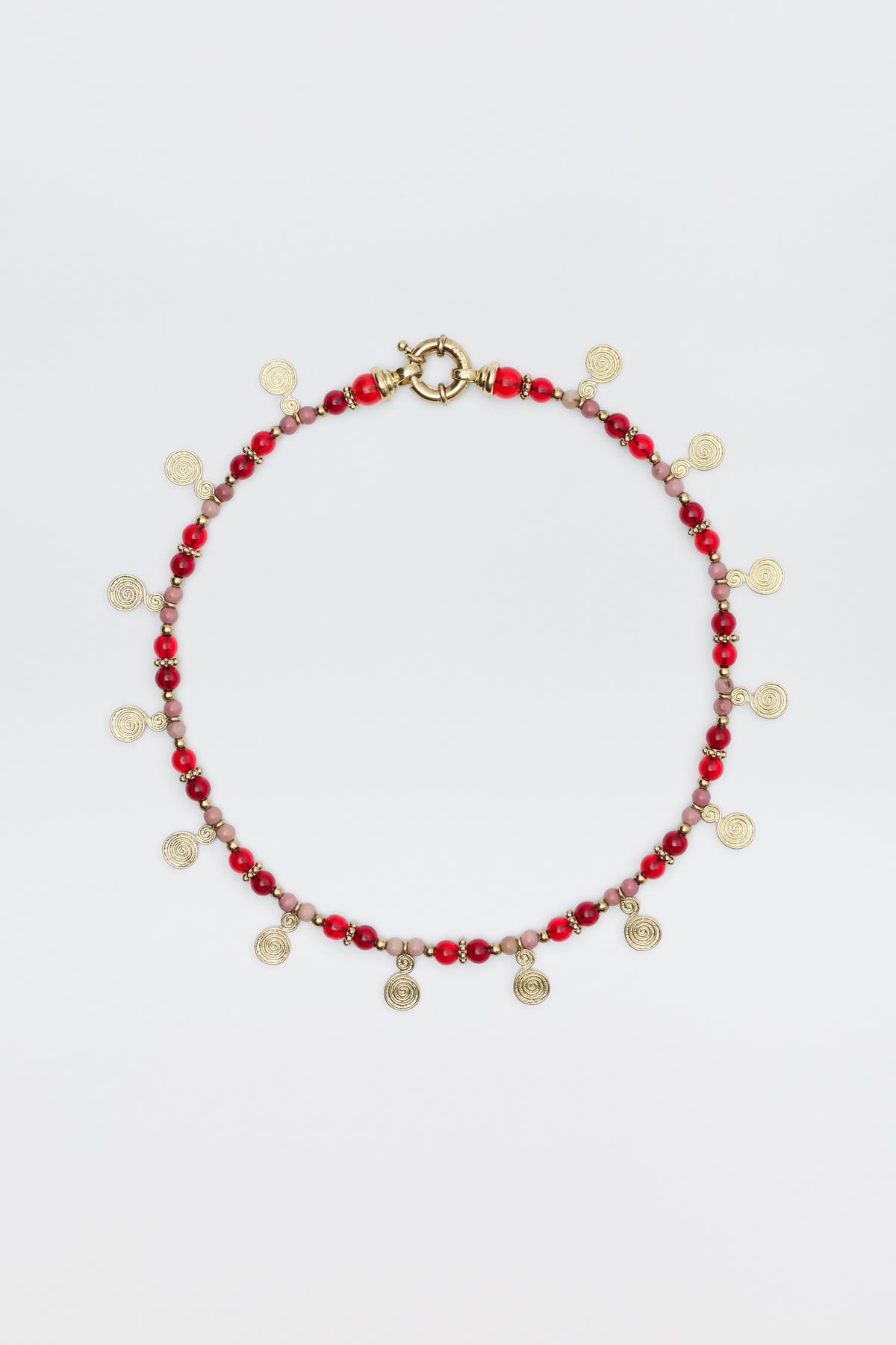 The Tala - Burgundy necklace features alternating red and pink beads with small gold spiral charms hanging evenly, shown on a white background.