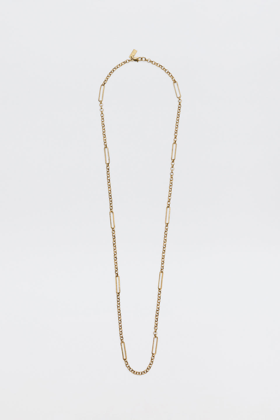The Eta - Gold necklace, featuring alternating small curb chain links and elongated rectangular links, is displayed against a plain white background.